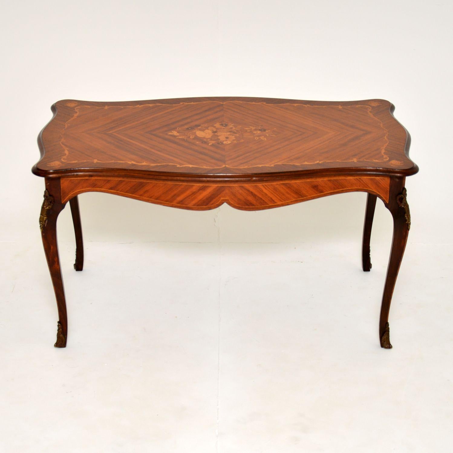 An absolutely beautiful antique French style coffee table made from various woods. this was made in France, it dates from around the 1930’s.

It has a gorgeous and shapely design, the top is inlaid in various woods including satin wood, king wood