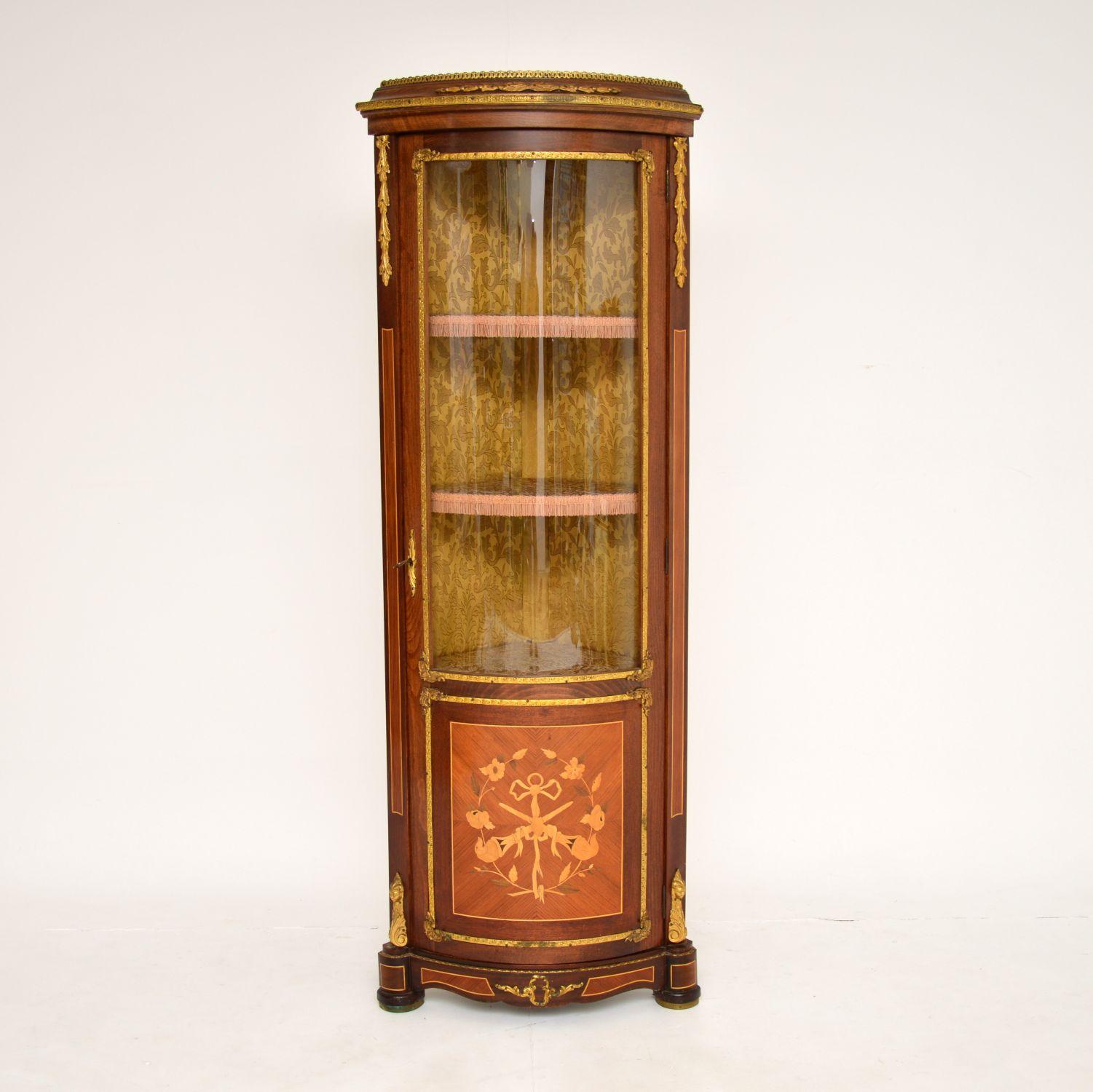 A beautiful antique French corner cabinet with stunning marquetry and gilt bronze mounts, which I would date from around the 1930-50’s period.

This is a lovely compact size and is extremely well made. The gilt bronze mounts are of amazing