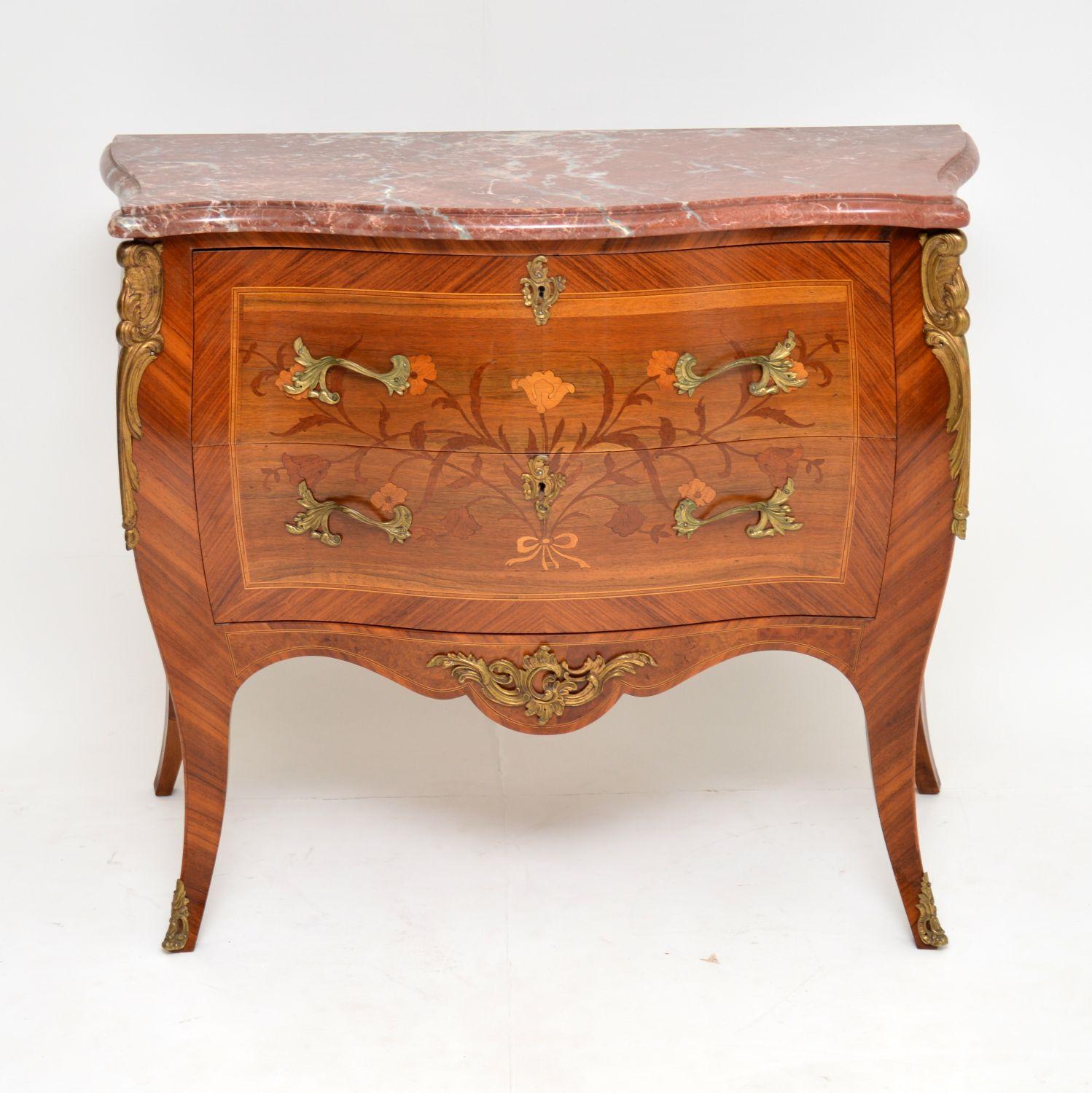 Antique French marble-top bombe commode chest in good condition and dating from circa 1920s period.

It has a rouge marble top which is also in good condition and lifts off from base. The wood is mainly kingwood and rosewood, plus many other more