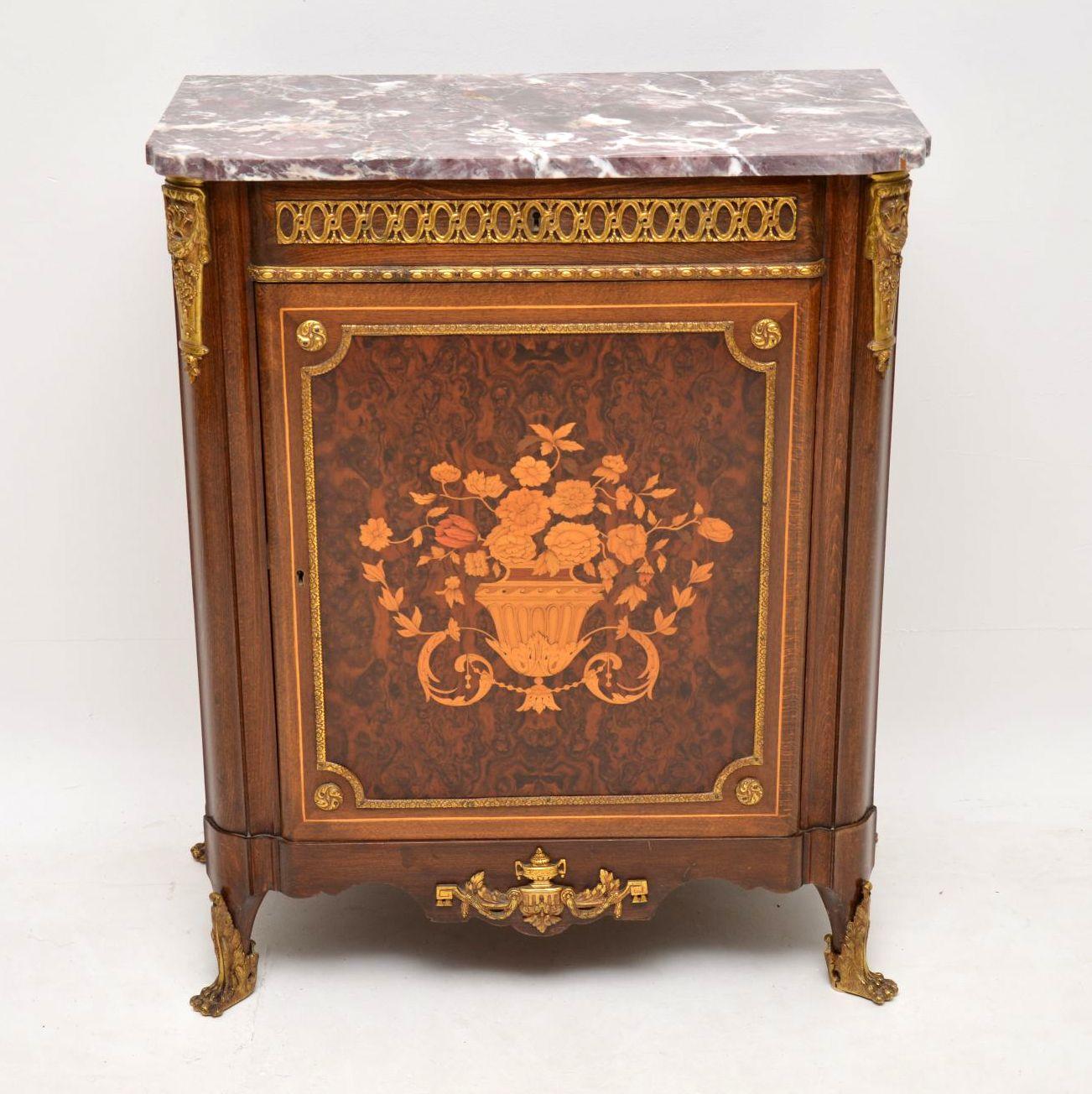 This antique French marble-top cabinet is wonderful quality and has nice small proportions. The marble top is very colorful and perfect. The floors marquetry on the door is absolutely stunning with amazing details and it’s set on a tight burr walnut