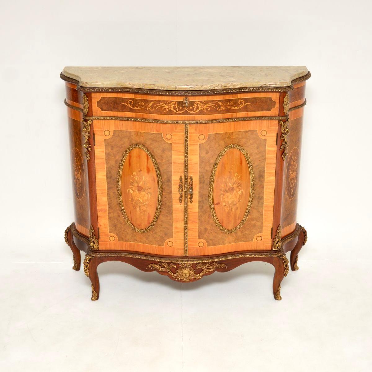 An absolutely gorgeous and extremely impressive antique French marble top cabinet. This was made in France, it dates from around the 1930’s.

It is made from a combination of burr walnut and satinwood, with beautiful floral patterns. There are