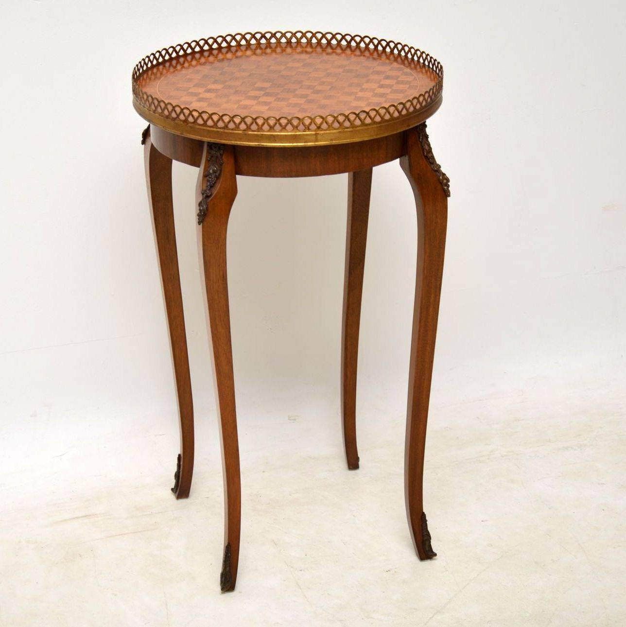 This French antique side table has a circular parquetry top with inlay and cross banding. It also has a gilt bronze pierced gallery and gilt bronze mounts. This table is in excellent condition and I would date it to around the 1910s-1920s