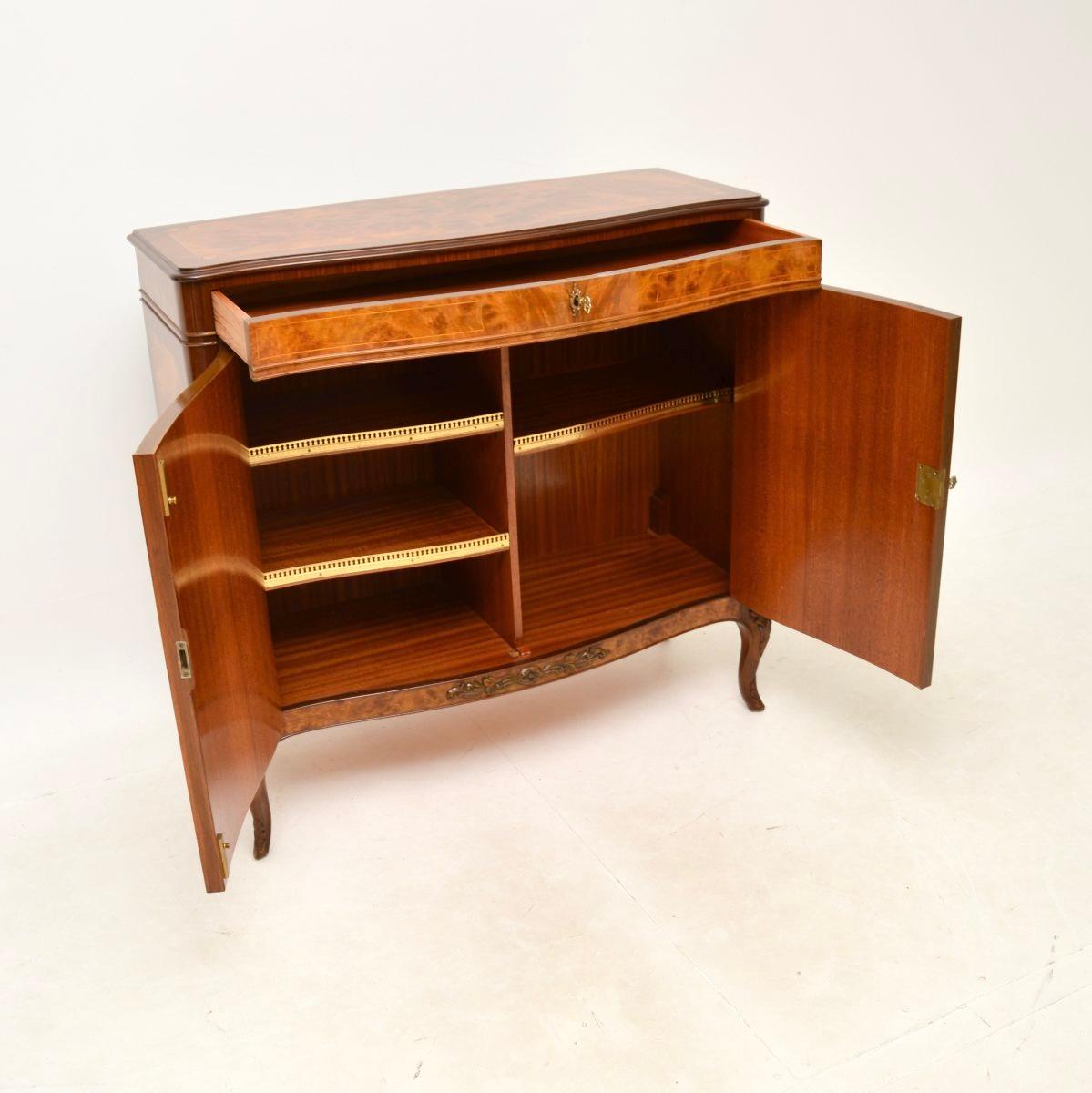 A stunning antique French inlaid walnut cabinet. This was made in France, it dates from around the 1930-50’s.

It is of superb quality and is beautifully made, predominantly from walnut and with inlays of various fruit woods. The burr walnut grain