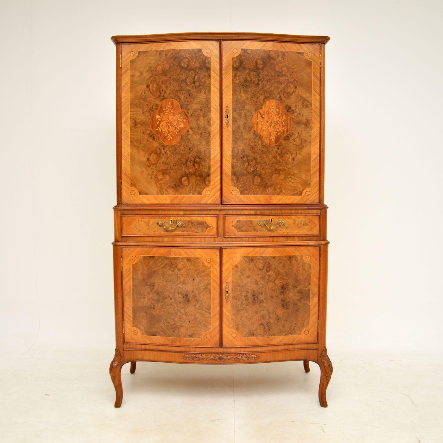 A beautiful and impressive inlaid walnut drinks cabinet in the antique French style, dating from around the 1930's period.

The quality is amazing, this is extremely well made with many fine features. It is made from a combination of burr walnut,