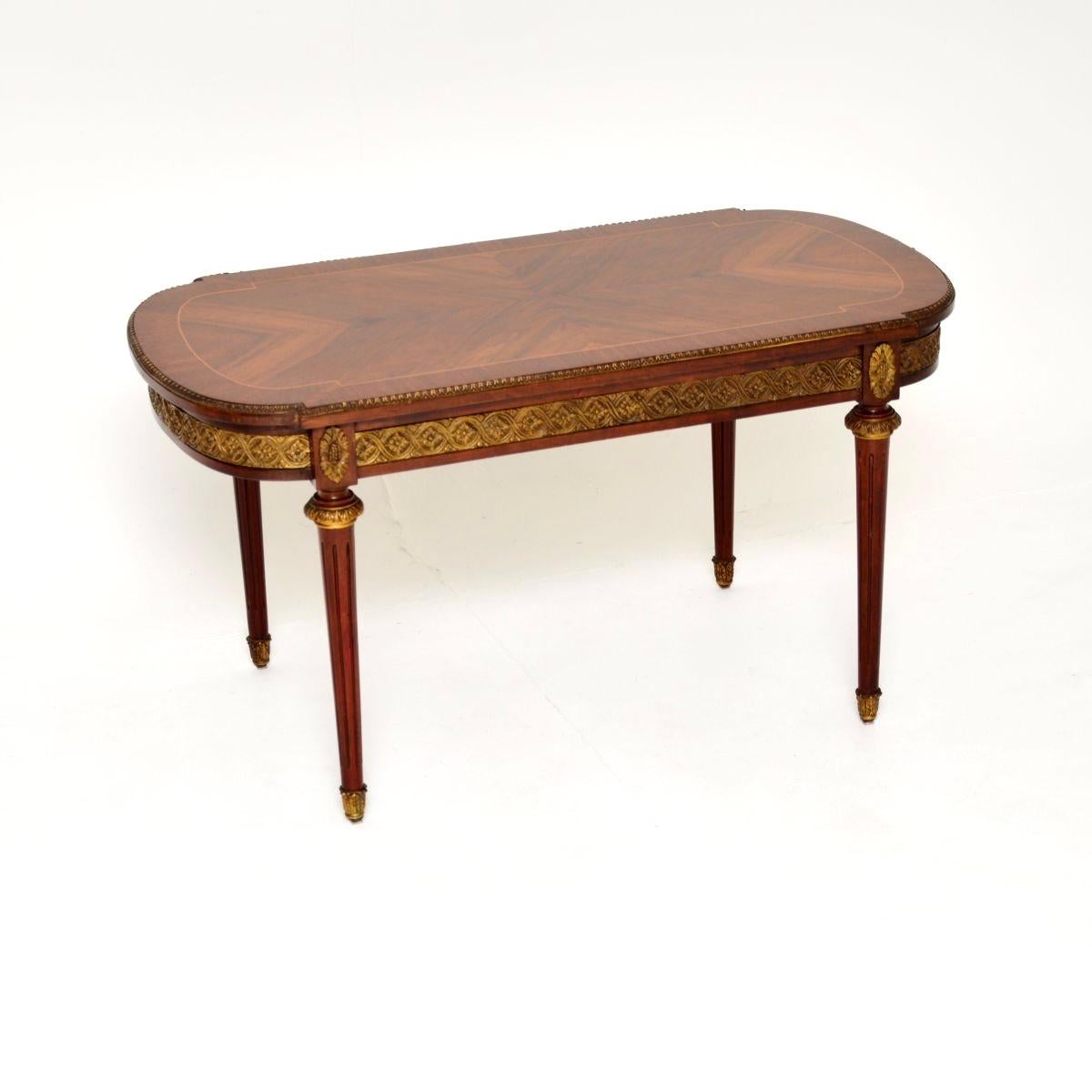 A beautiful antique French inlaid walnut ormolu mounted coffee table, dating from around the 1930’s.

This is of wonderful quality, it is a useful size and has a gorgeous design. The walnut top has nicely shaped edges with and inlaid border of satin