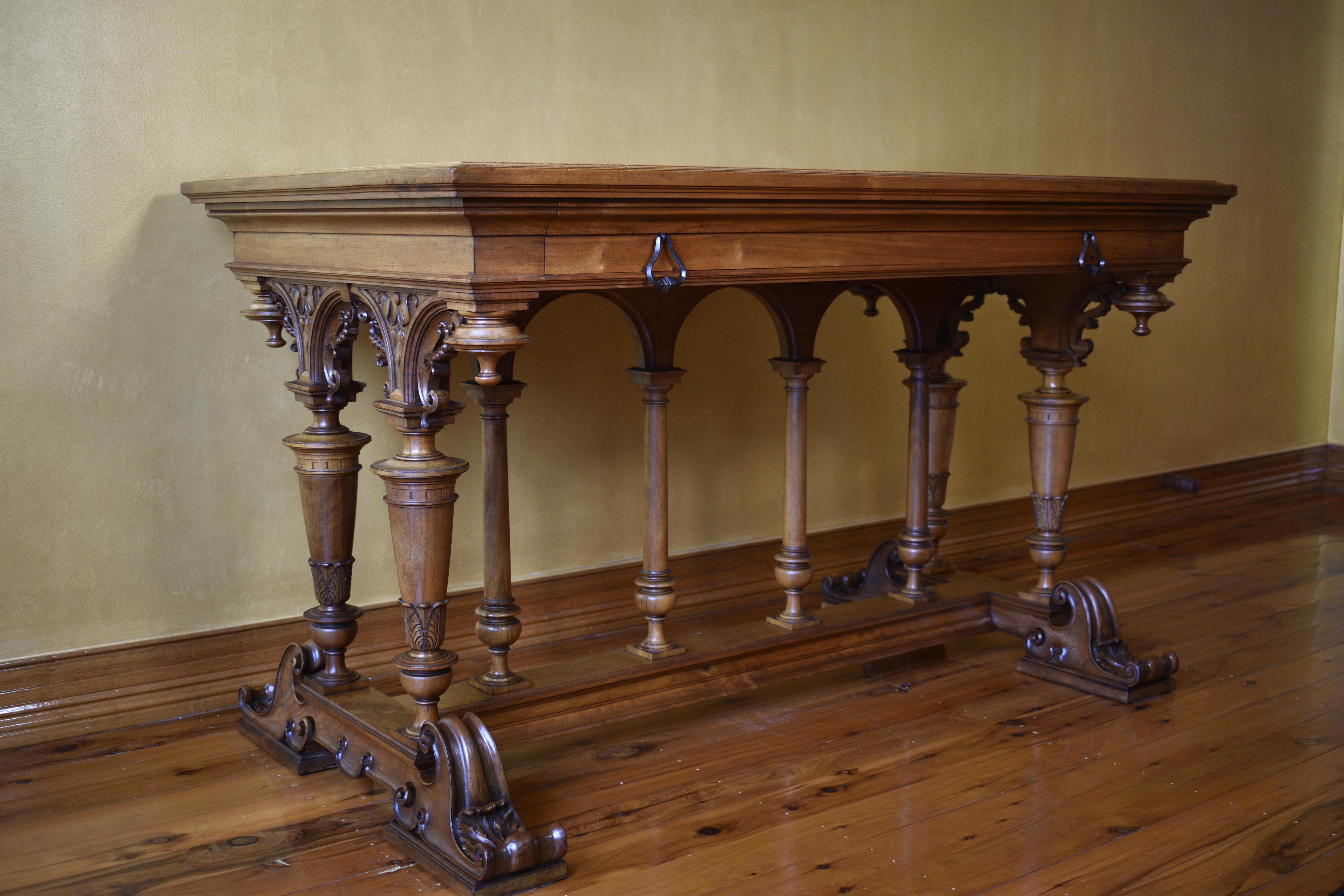 Large single Drawer, handmade dovetails, oat internal timbers, turned columns to stretcher base, intricate high quality carved pedestal ends, table top has been repainted.

circa:1870

Material: Walnut

Country of Origin: