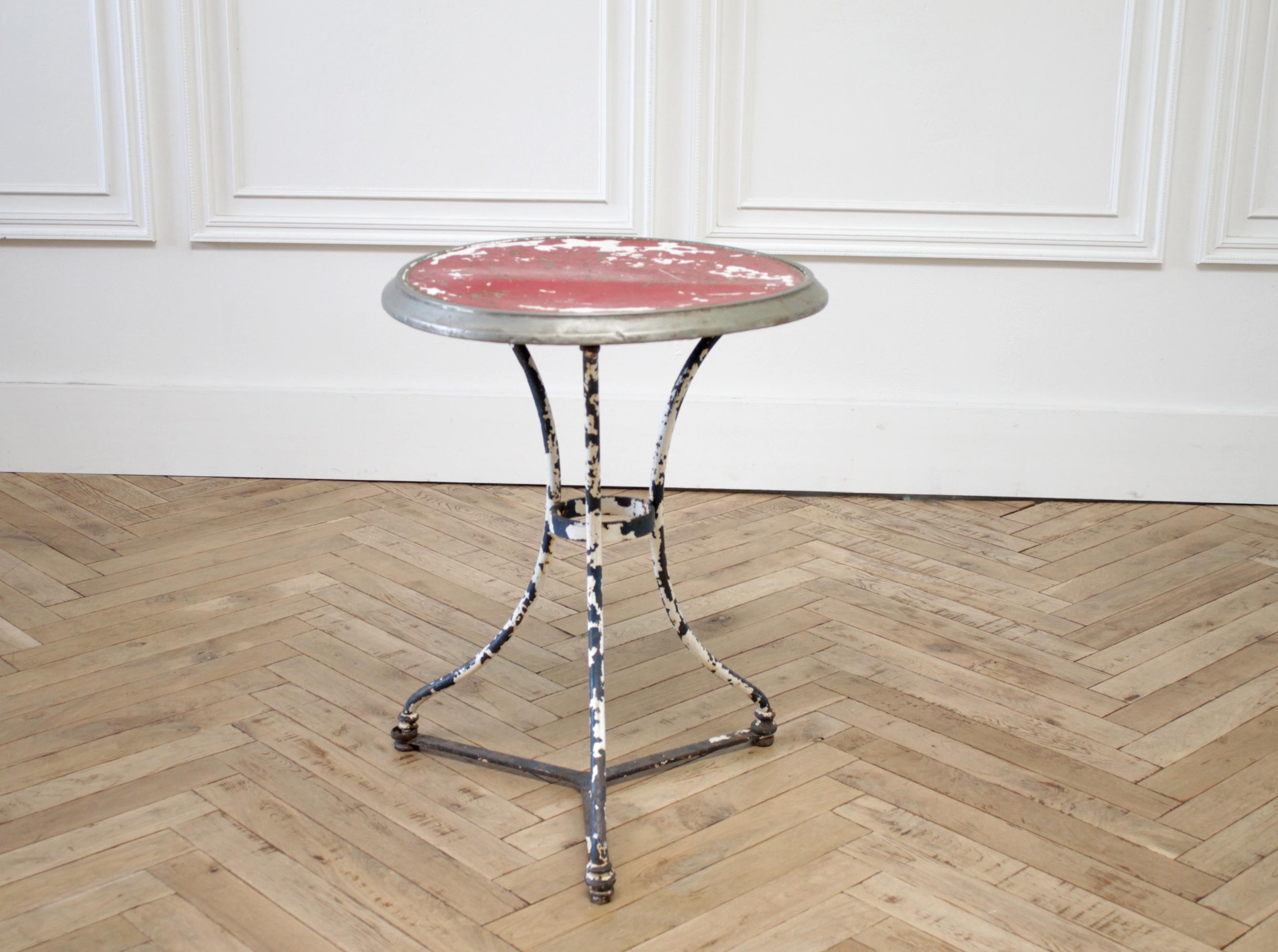 Antique French iron and wood side table
Solid iron table, with wood and metal top. Original painted finish in red, and blue chipping paint. Table is solid and sturdy, tabletop surface is not completely flat, see photos. Still usable for books and