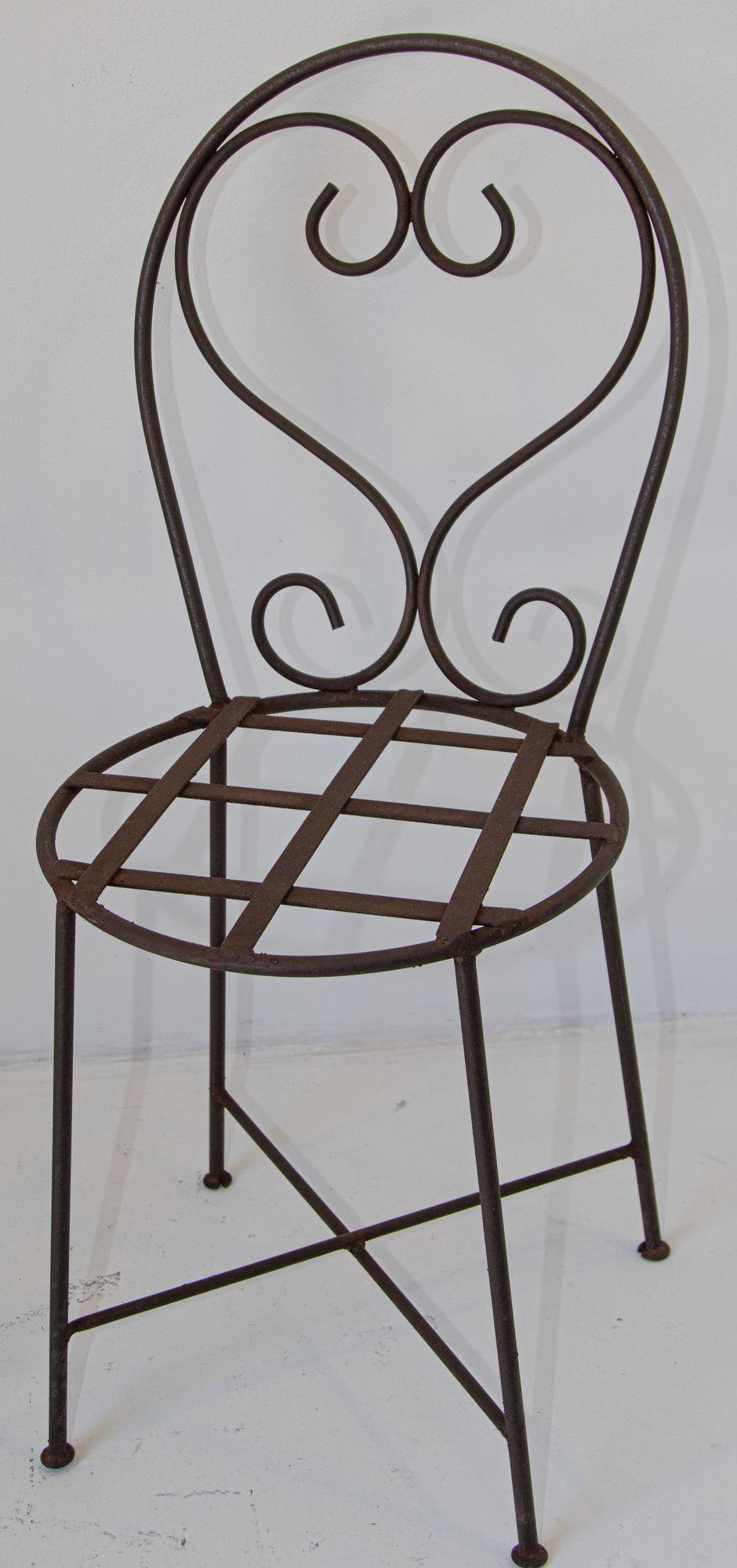 Antique pair of French Iron Forged heart back outdoor garden chairs.
Heart back garden chairs
Dimensions: 
Measures: 36” H
Seat height: 18”
Seat depth: 15.5” x 15.5 Diameter.
Great antique patio, garden outdoor chairs, restored cleaned and