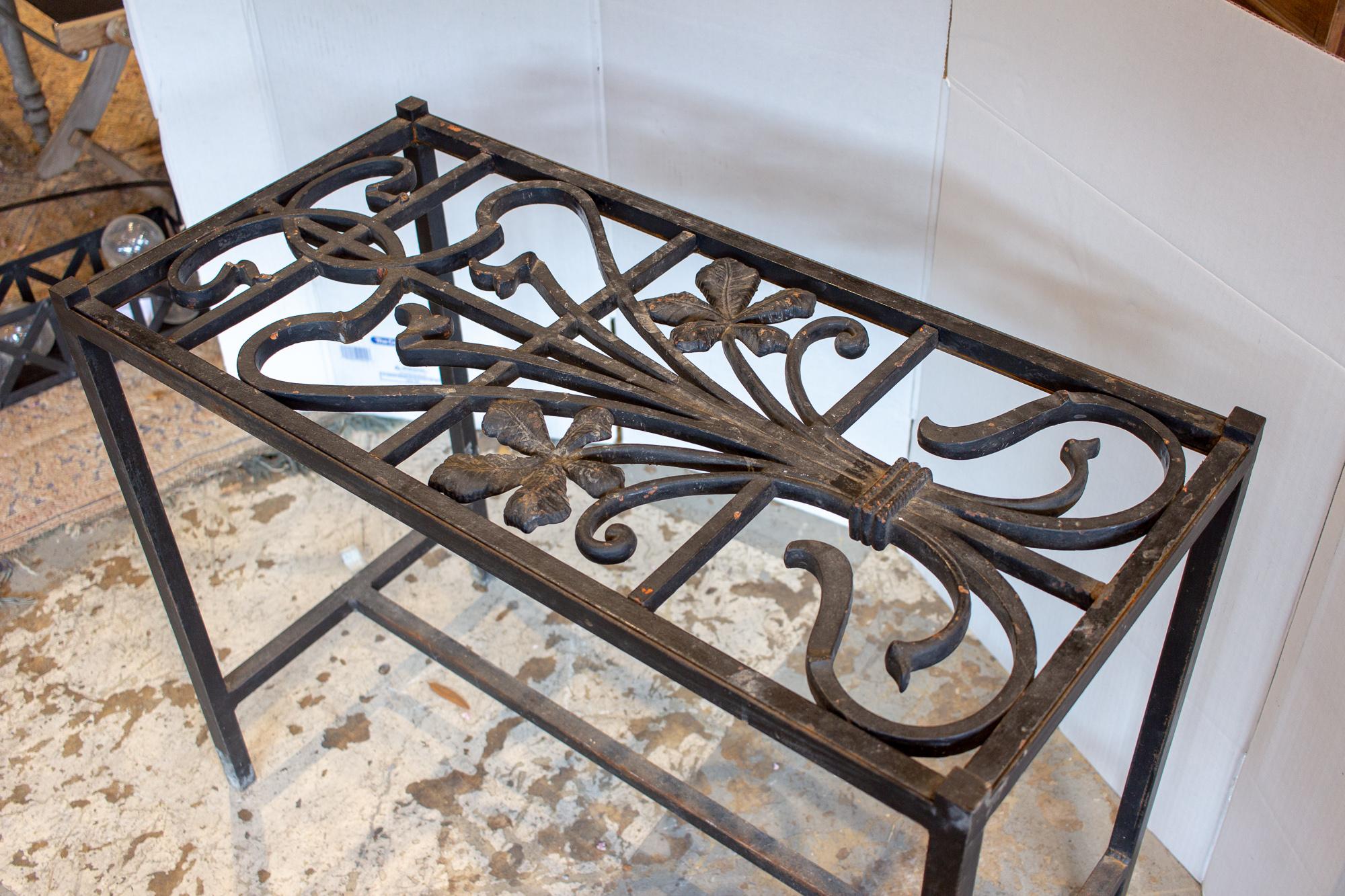 This iron console table has been crafted with a wonderful, iron Art Nouveau top, with a simple wrought iron table frame. The piece could be used indoors or out, as a small accent table. The floral details of the top make a feminine statement piece