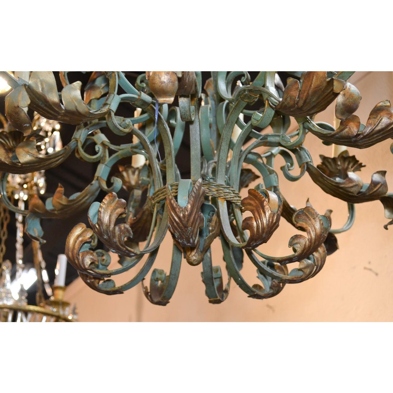 Fabulous antique French chandelier, handcrafted with contrasting gilt and antique green patinated iron. Decorated overall with fanciful scrolls and acanthus leaf accents. Ten lights with leaf spray candle cups,

circa 1910.