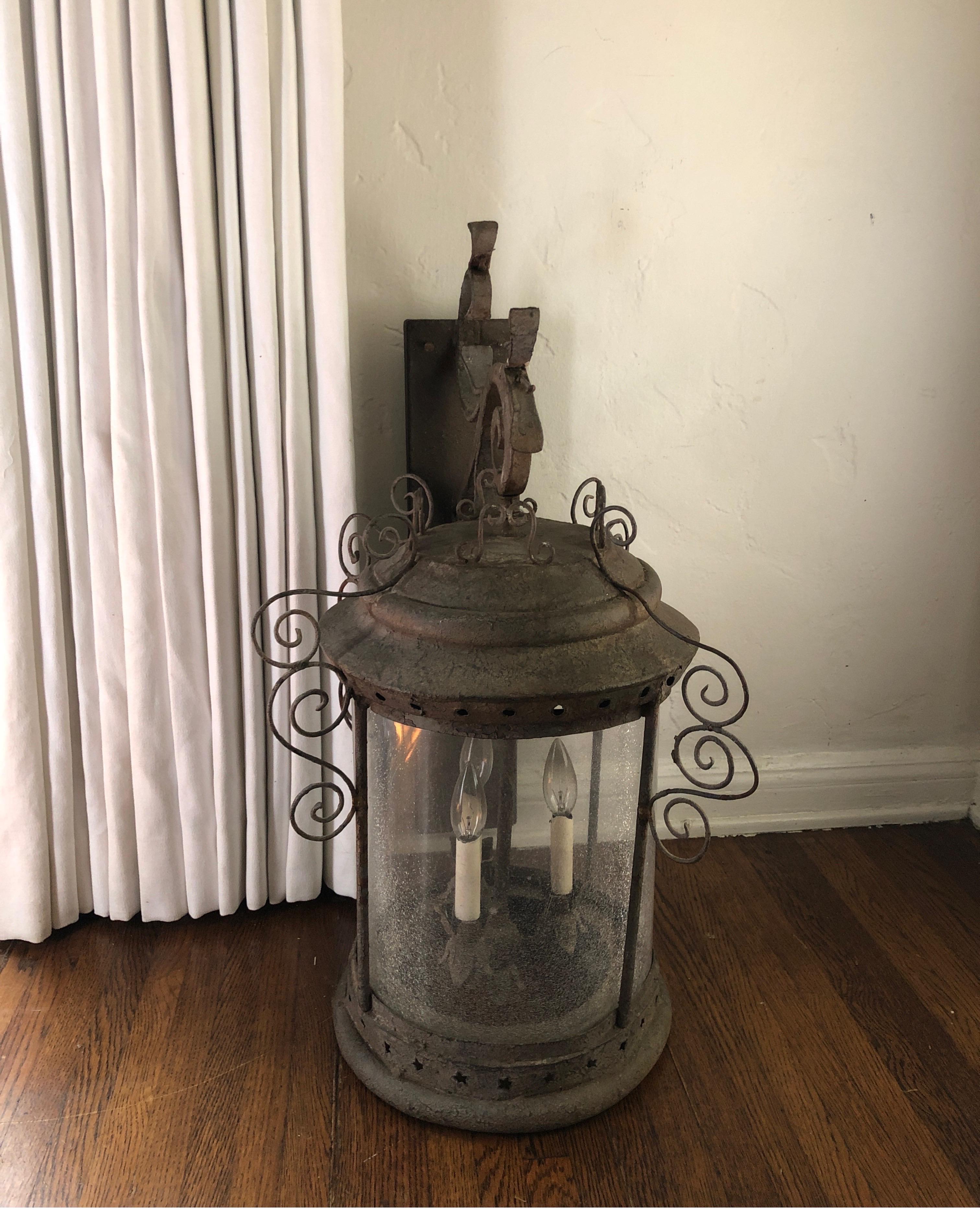 Beautiful distressed lantern approximate 27” height and 30 height including bracket. 19” depth from wall. 18” wide.
Old glass with crackle appearance. Scroll iron work and 3 light candelabra inside.
