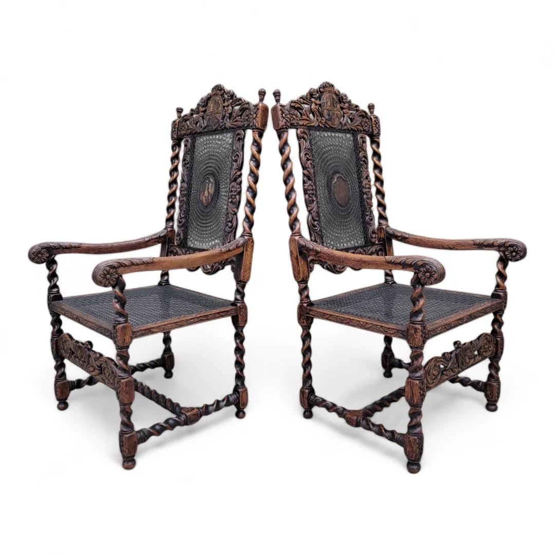 Stunning 19th Century Jacobean/Renaissance Revival carved walnut armchairs. Chairs feature ornate spiral carved barley twist walnut frames with leafy scroll work, cherub figures on the upper rail and Spread Winged Eagle on The lower stretcher. Tall