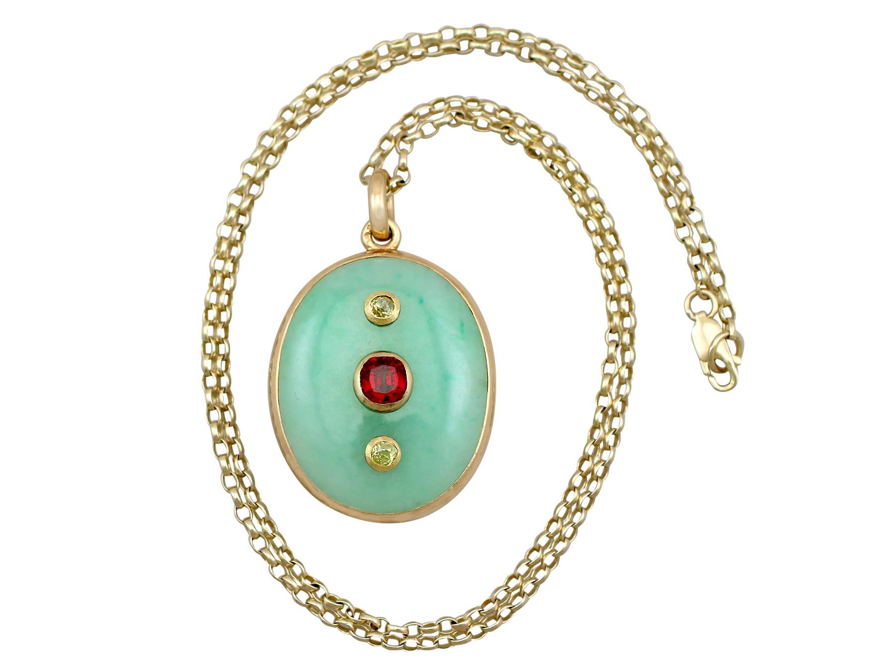A stunning antique French jade and 0.98 carat garnet, 0.23 carat diamond and 18 karat yellow gold locket pendant; part of our diverse antique jewelry and estate jewelry collections.

This stunning, fine and impressive antique jade pendant has been