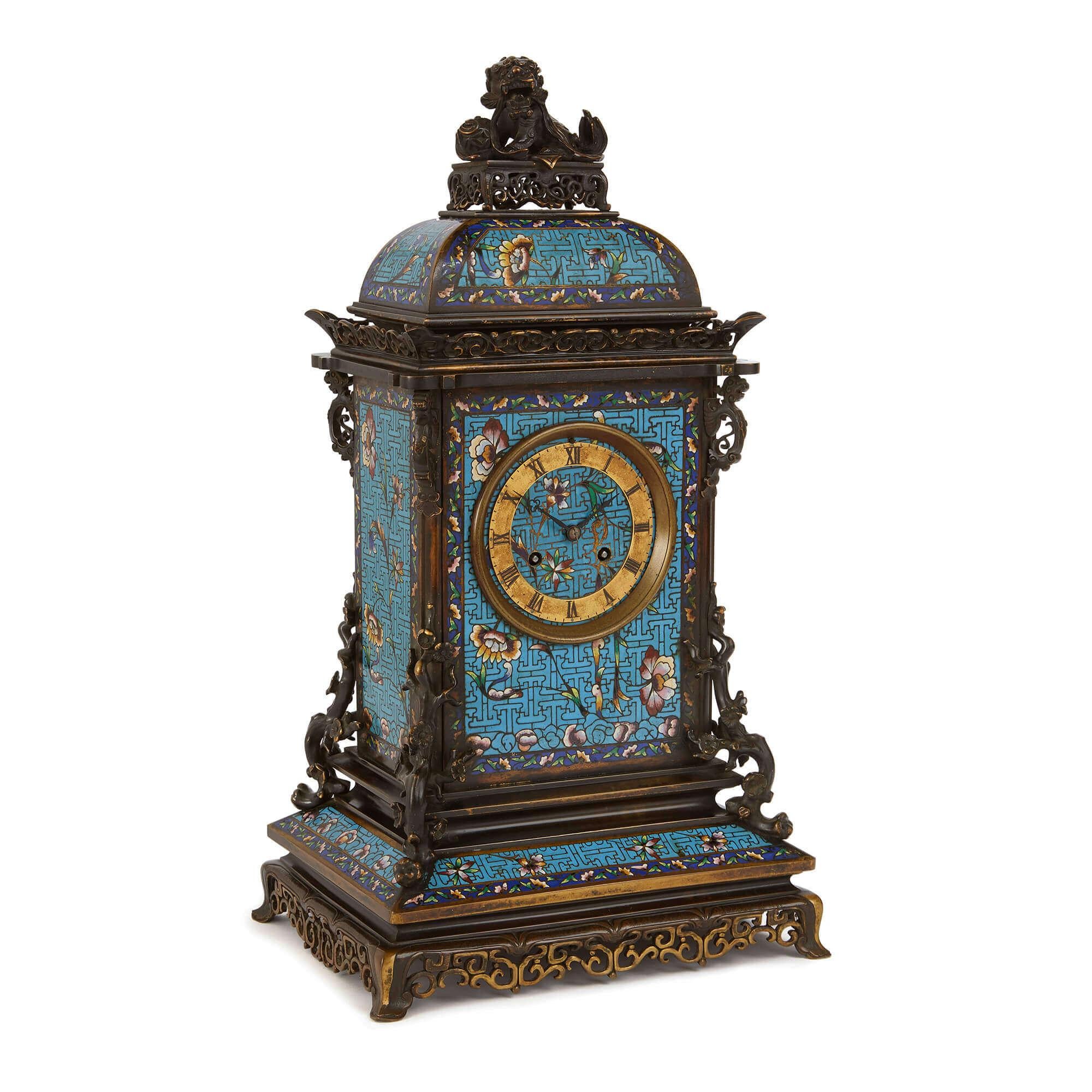 Antique French Japonisme mantel clock with floral Champlevé enamel
French, late 19th century
Dimensions: Height 51cm, width 27.5cm, depth 22cm

Beautifully wrought from patinated bronze and champlevé enamel, this mantel clock is designed in the