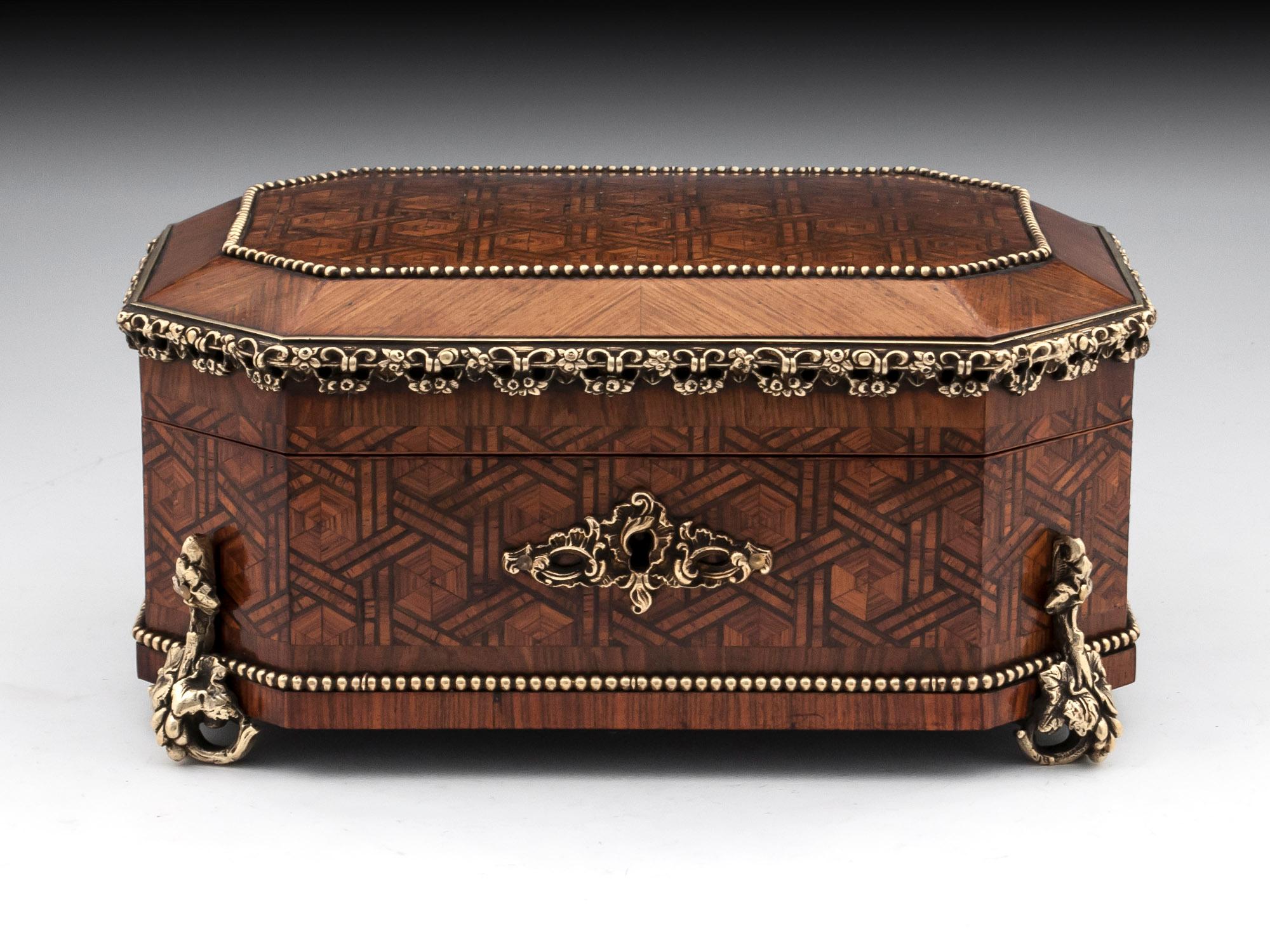 Antique French jewelry box by Tahan, its veneered in walnut with beautiful bronze mounts with ornate feet and escutcheon. 

The interior of this exquisite French jewelry box is lined in a rich maroon velvet and silk paper and features a removable