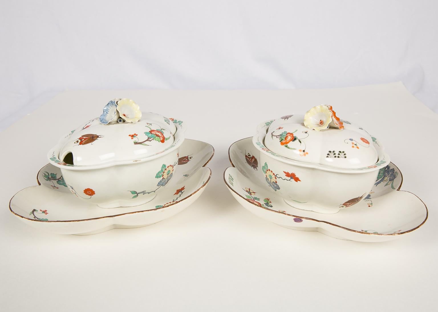 A pair of antique 18th century French porcelain sugar tureens and trays made by the Chantilly manufactory in the Japanese Kakiemon style circa 1735-1745. Our pair of charming sauce tureens with their trays, feature a palette of strong, bright colors