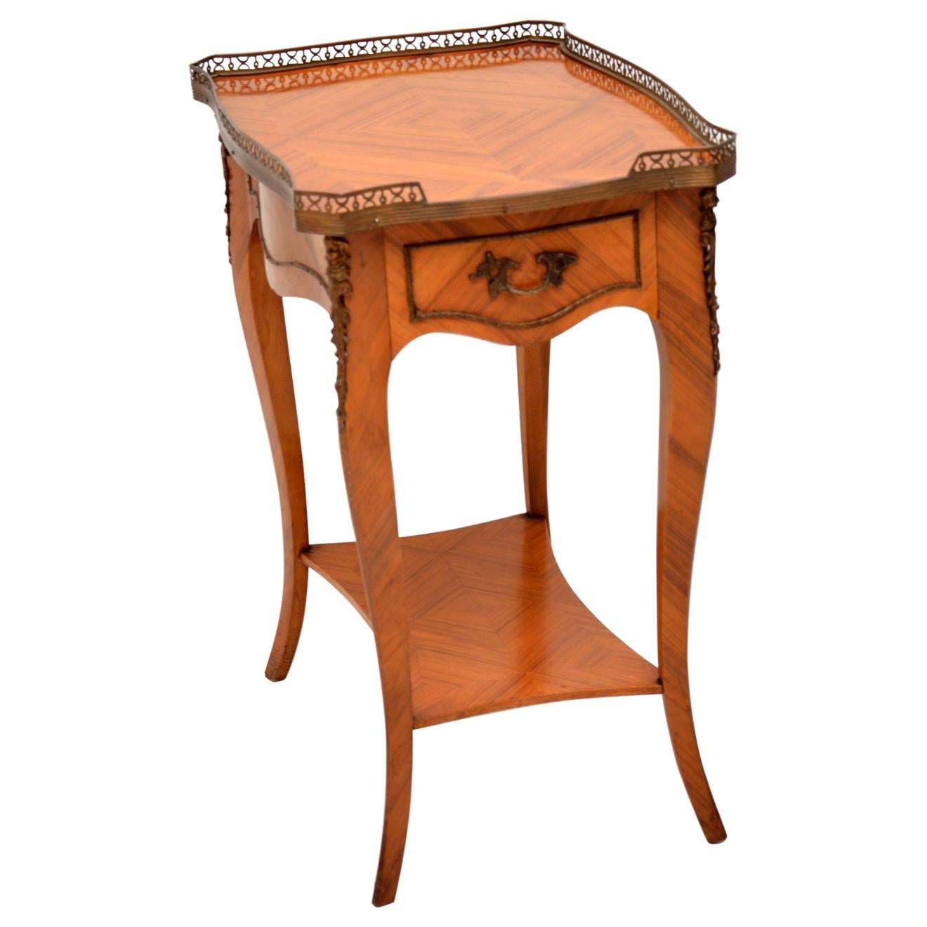 Antique French Louis XV style wood side table in excellent condition and dating to circa 1930s period.

It’s in excellent condition having just been French polished and the wood veneers have some lovely patterns. This table is panelled all the way