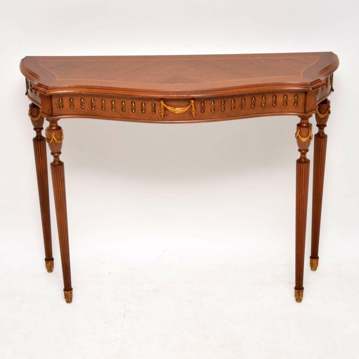 This antique French style console table has nice slim proportions from back to front and is in excellent condition. I would date this table to circa 1930s period and the wood looks like a combination of kingwood and walnut. The top has a kingwood