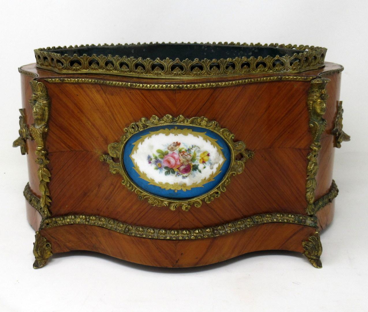 Stylish French twin handle kingwood jardinière of traditional oval form, with ormolu gallery pierced rail and ornate ormolu twin handles and central hand painted soft paste Sevres porcelain plaque depicting hand painted still life of flowers,