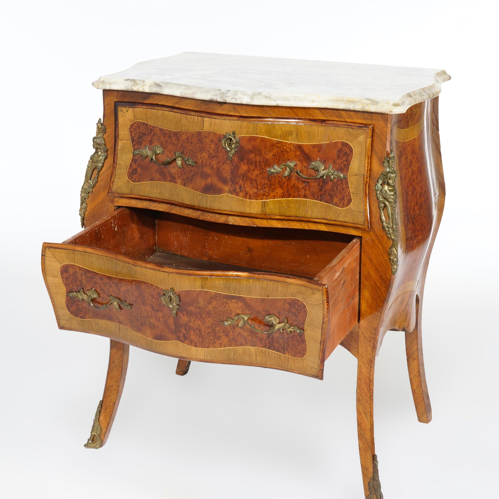 An antique French bombe commode offers shaped and beveled marble top over kingwood and rosewood case having swell front, two drawers, inlaid decoration and cast ormolu throughout, raised on cabriole legs, c1910

Measures- 30.5''H x 25.25''W x