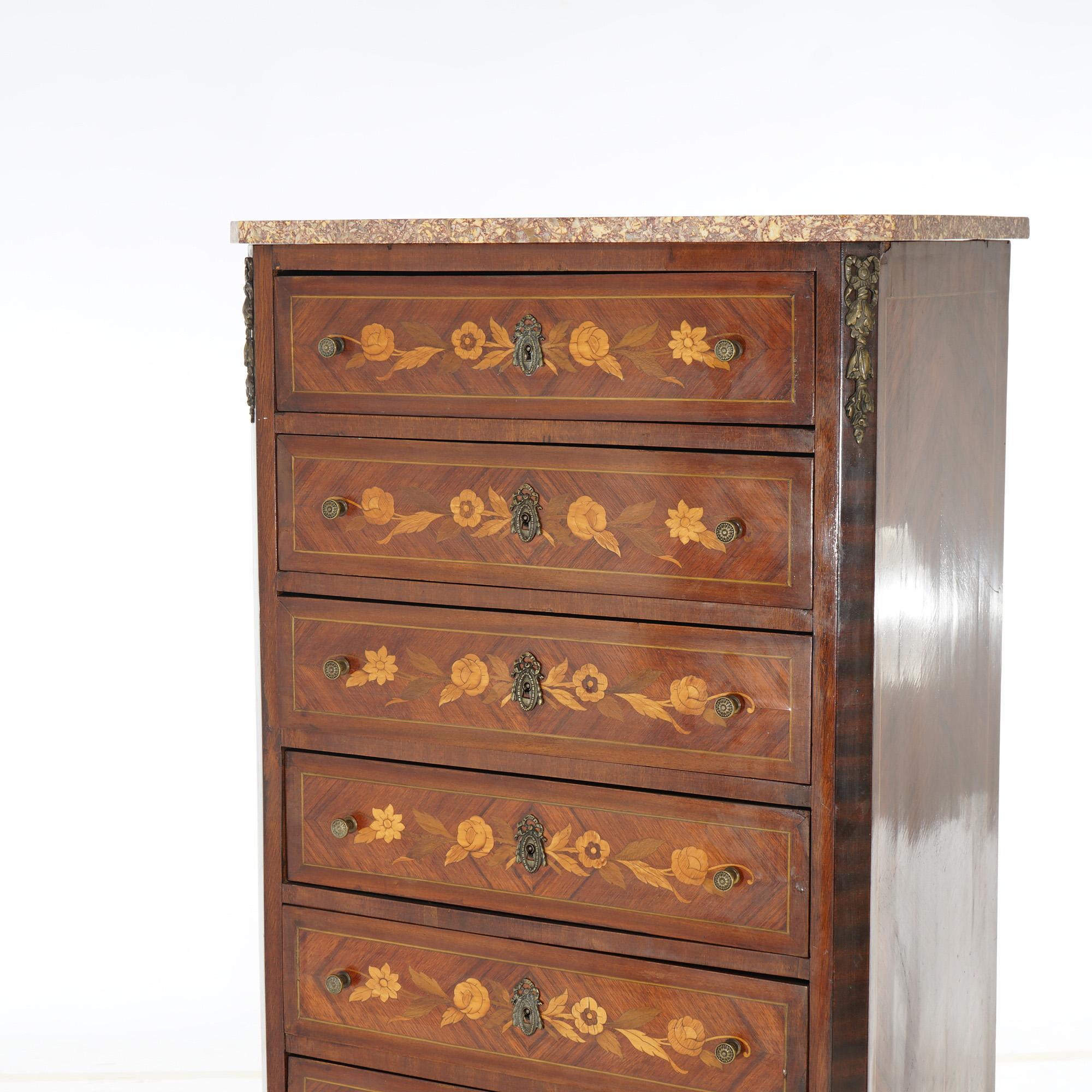 An antique French lingerie chest offers marble top case with kingwood facing, satinwood, floral marquetry inlay, seven drawers, ormolu mounts and raised on cabriole legs, 19th century

Measures- 55''H x 27''W x 16.25''D

Catalogue Note: Ask about