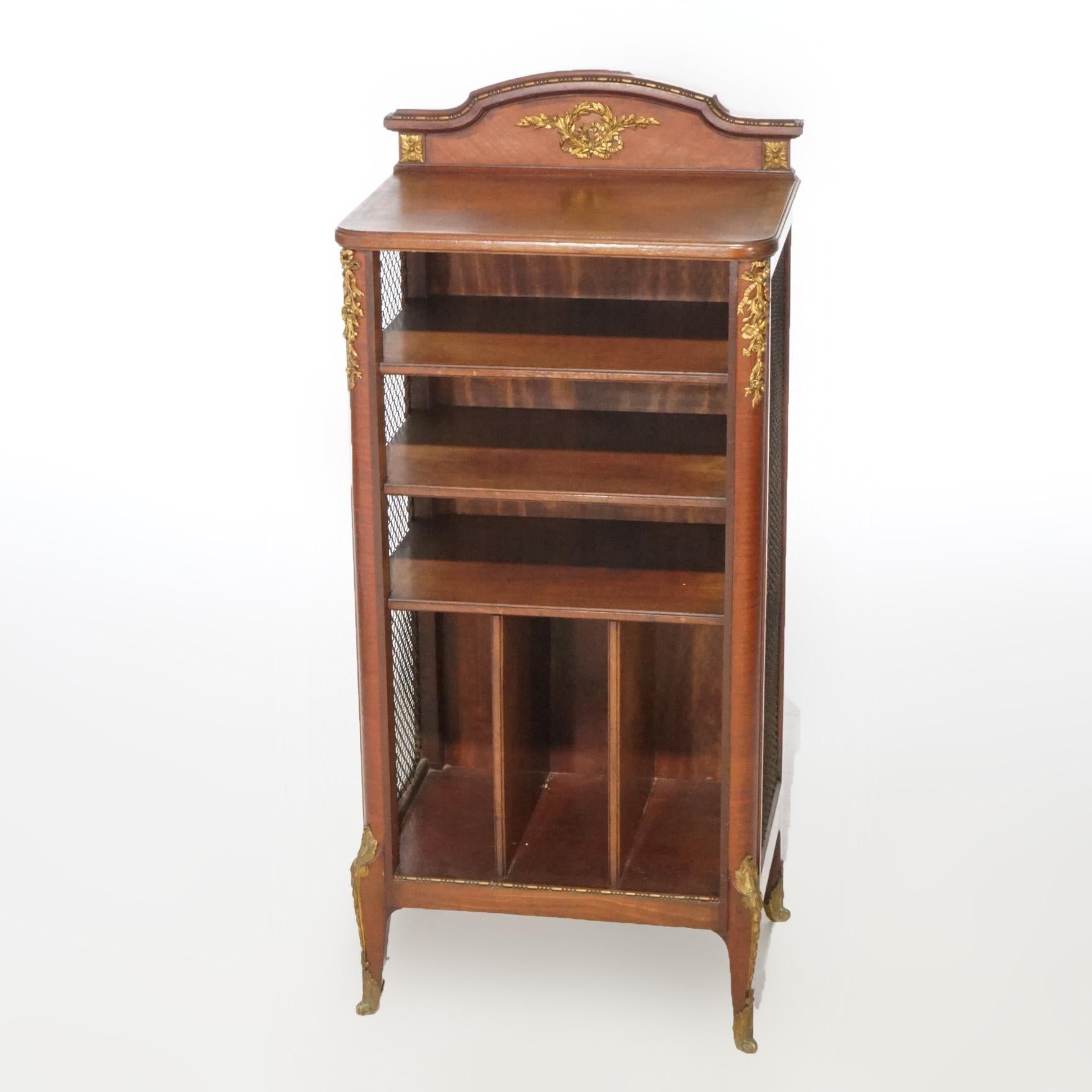 An antique French open music cabinet offers Kingwood and Satinwood construction with mesh sides, foliate cast ormolu and raised on cabriole legs, circa 1920

Measures - 45