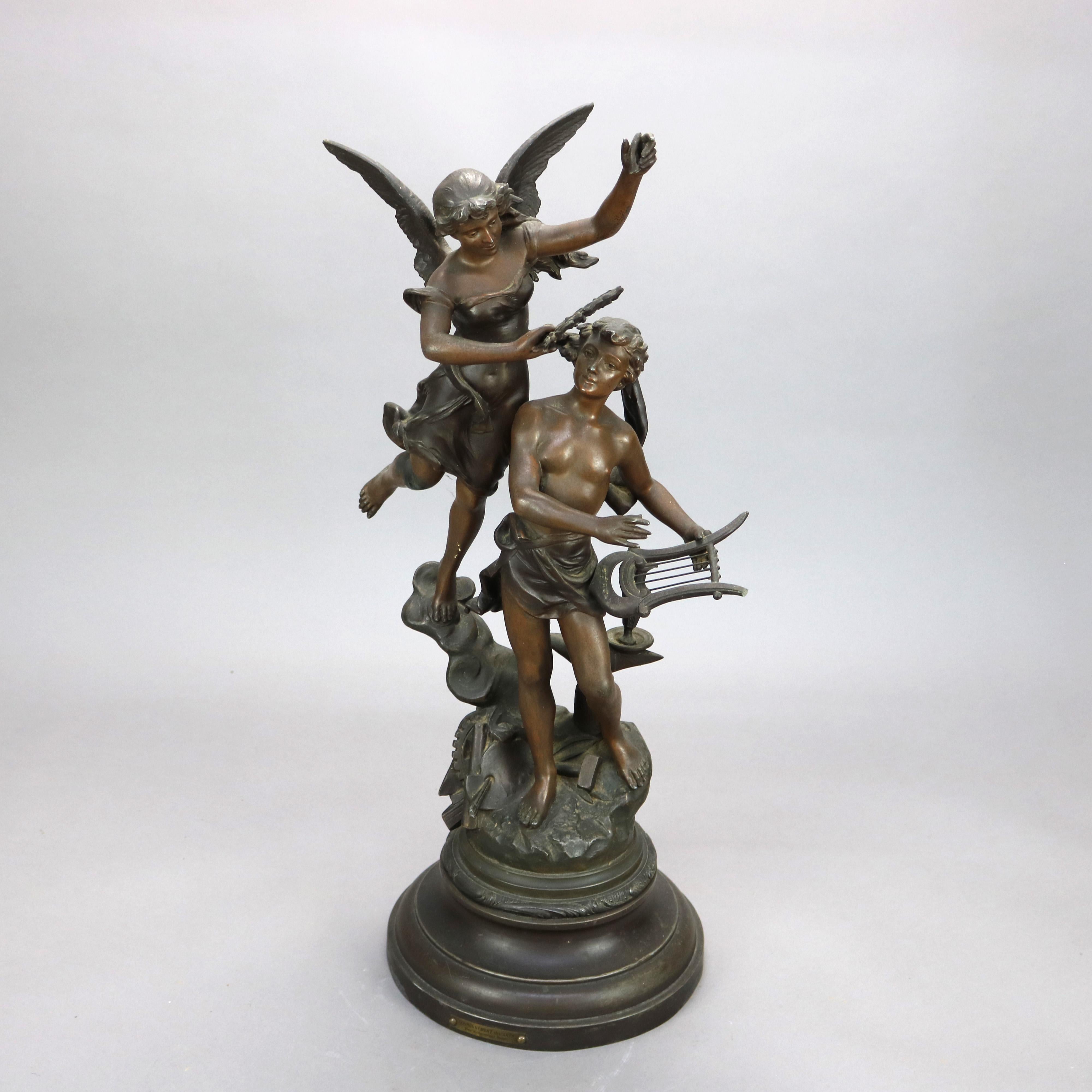 An antique French Henryk Kossowski (1855-1921) bronzed cast spelter sculpture titled “Couronnement des Arts” (Coronation of Art) depicts Neoclassical angel placing a crown wreath on the head of young man surrounded by elements of the arts, Kossowski