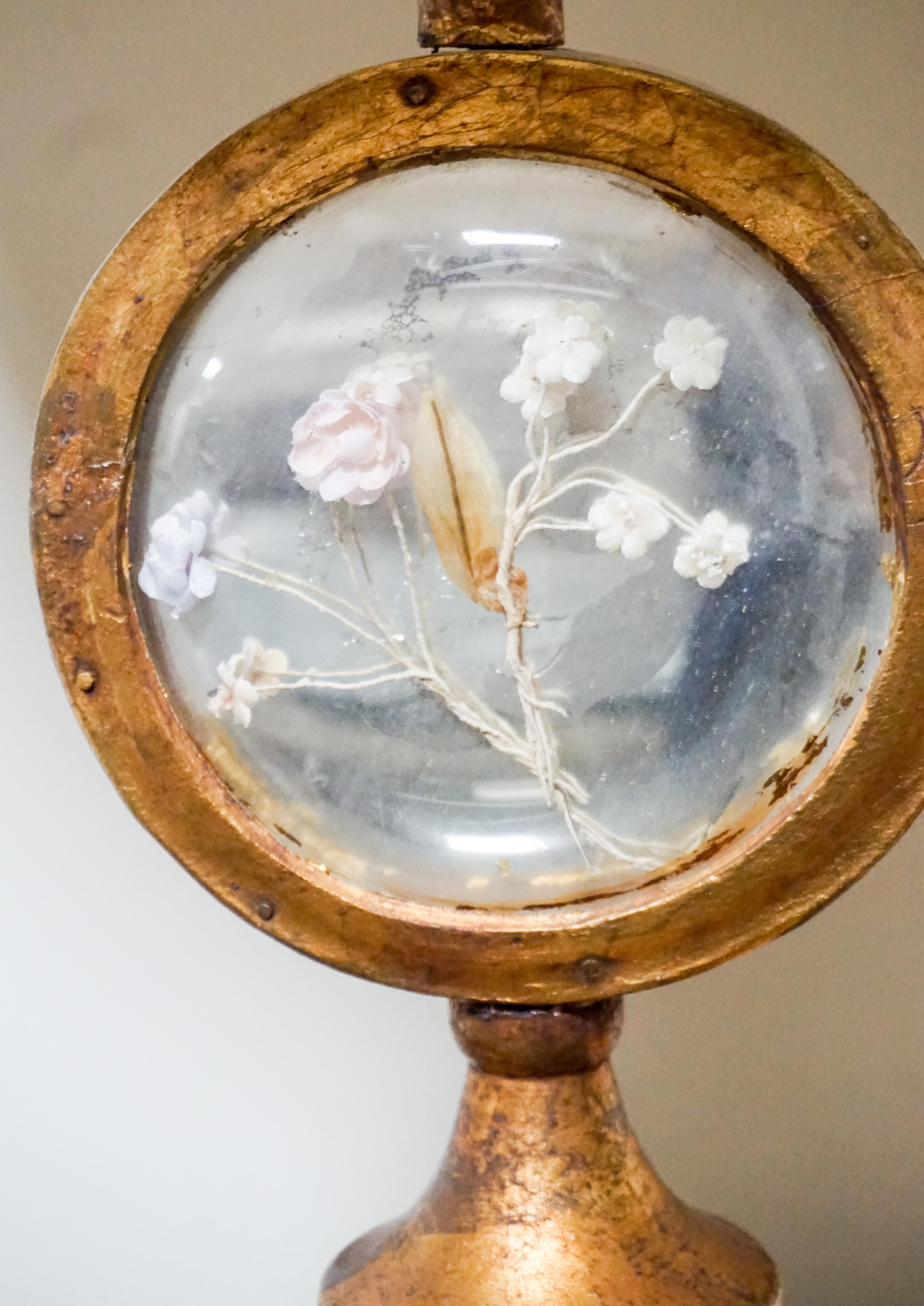 Here we have a lovely lamp from France featuring delicate flowers inside a glass dome. 

Origin: France, circa 1880.