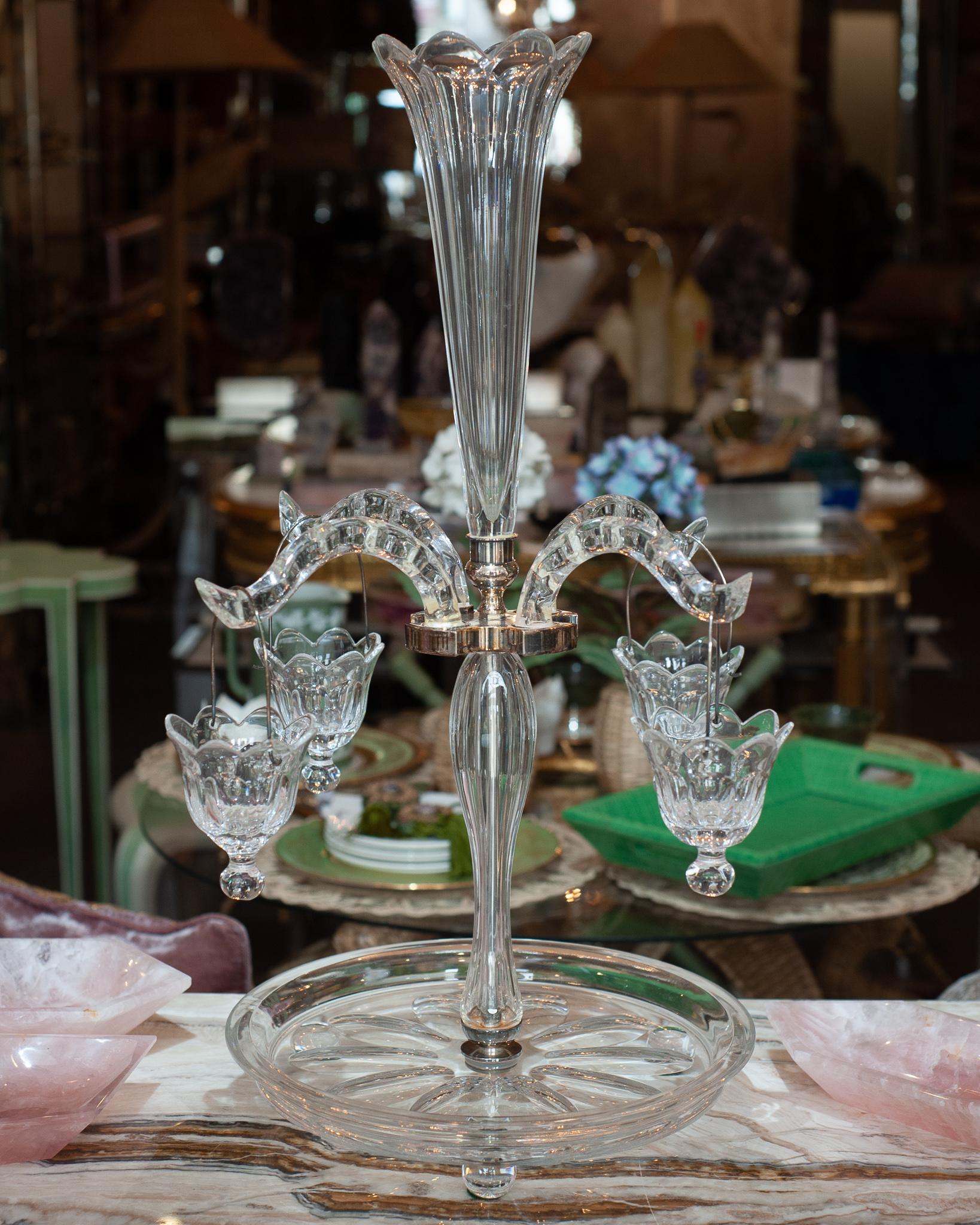 When setting the dinner table, special attention should be paid to your centerpiece. This stunning grand Antique French glass Epergne is the perfect accessory to grace your table. Crystal arms float from a silver-plated frame on the center stem, and