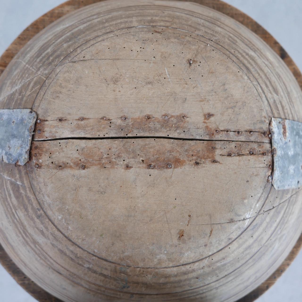 A large wooden bowl. 

France, 19th century. 

Turned lines around the bowl. 

Historical naive metal work repairs, adding character. 

Historical worm since treated as a precaution. 

Location: Belgium Gallery. 

Dimensions: 55 W x 52 D