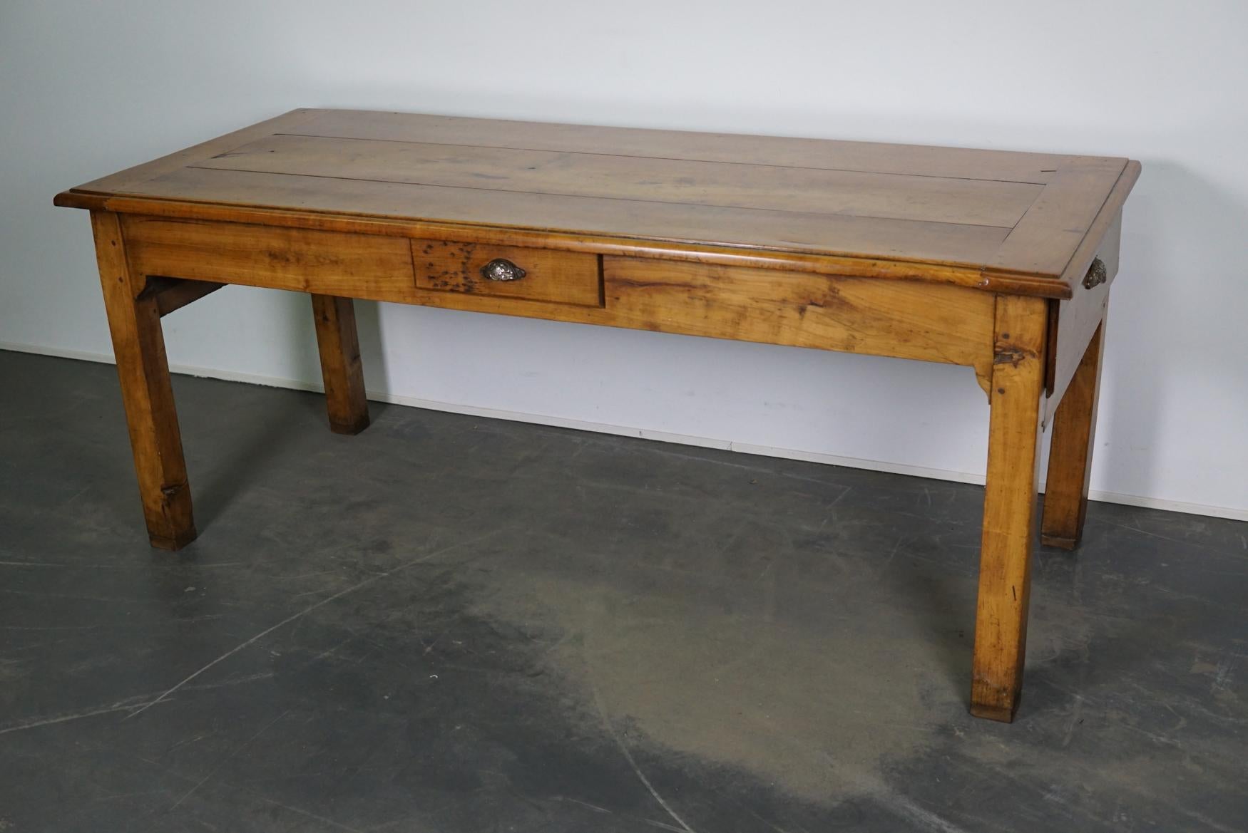 This antique French table was made from cherry in the late 19th century and was used as a prepping table in a kitchen in it's early life. The two large drawers were used to store the baguettes and there is also one smaller drawer. It is in a very