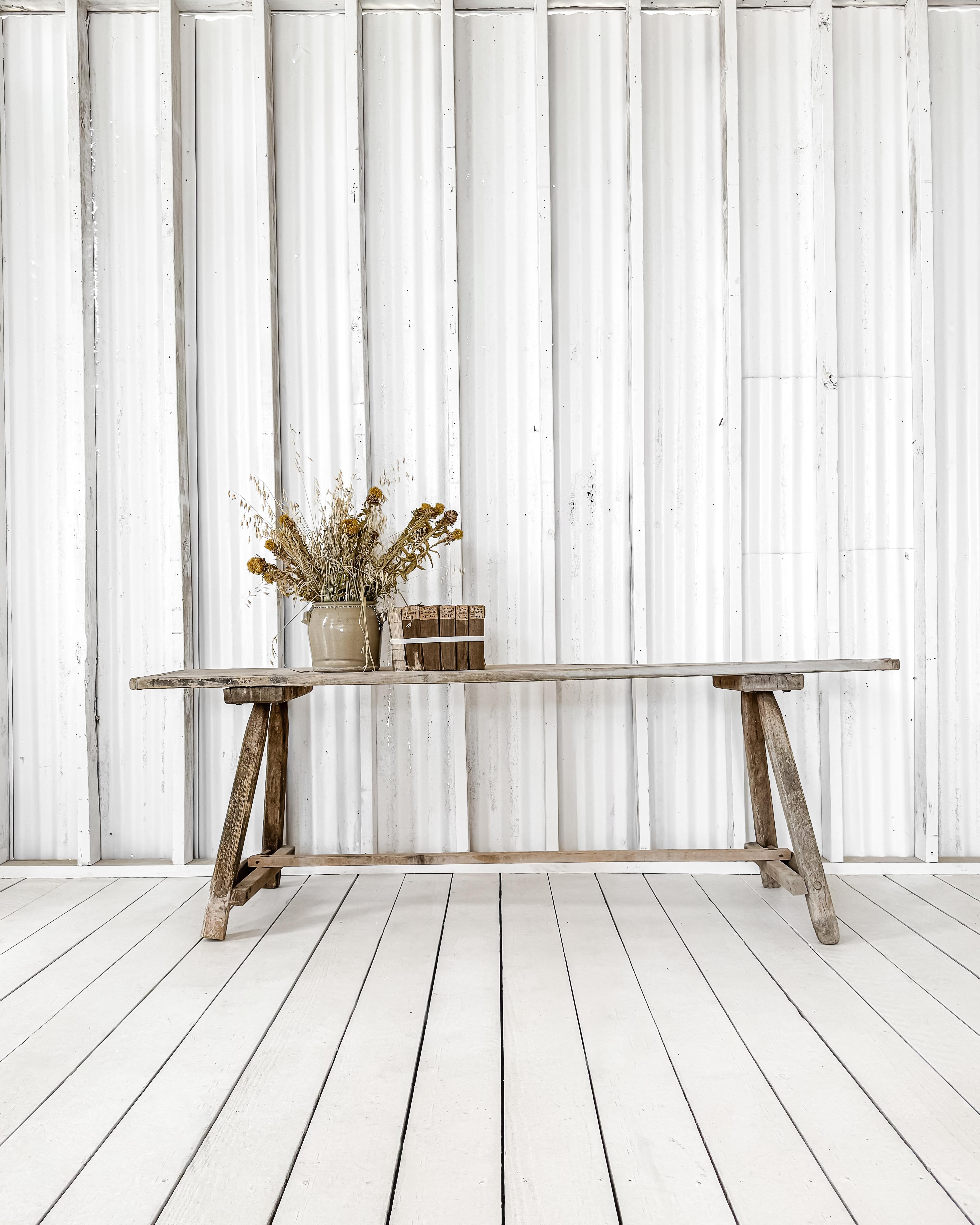Handcrafted rustic washing table, featuring a single board top finished with breadboard ends and A-frame legs with a low trestle support. Made from elm, the table is worn and weathered with a beautiful patina. Perfect in size to use as a console