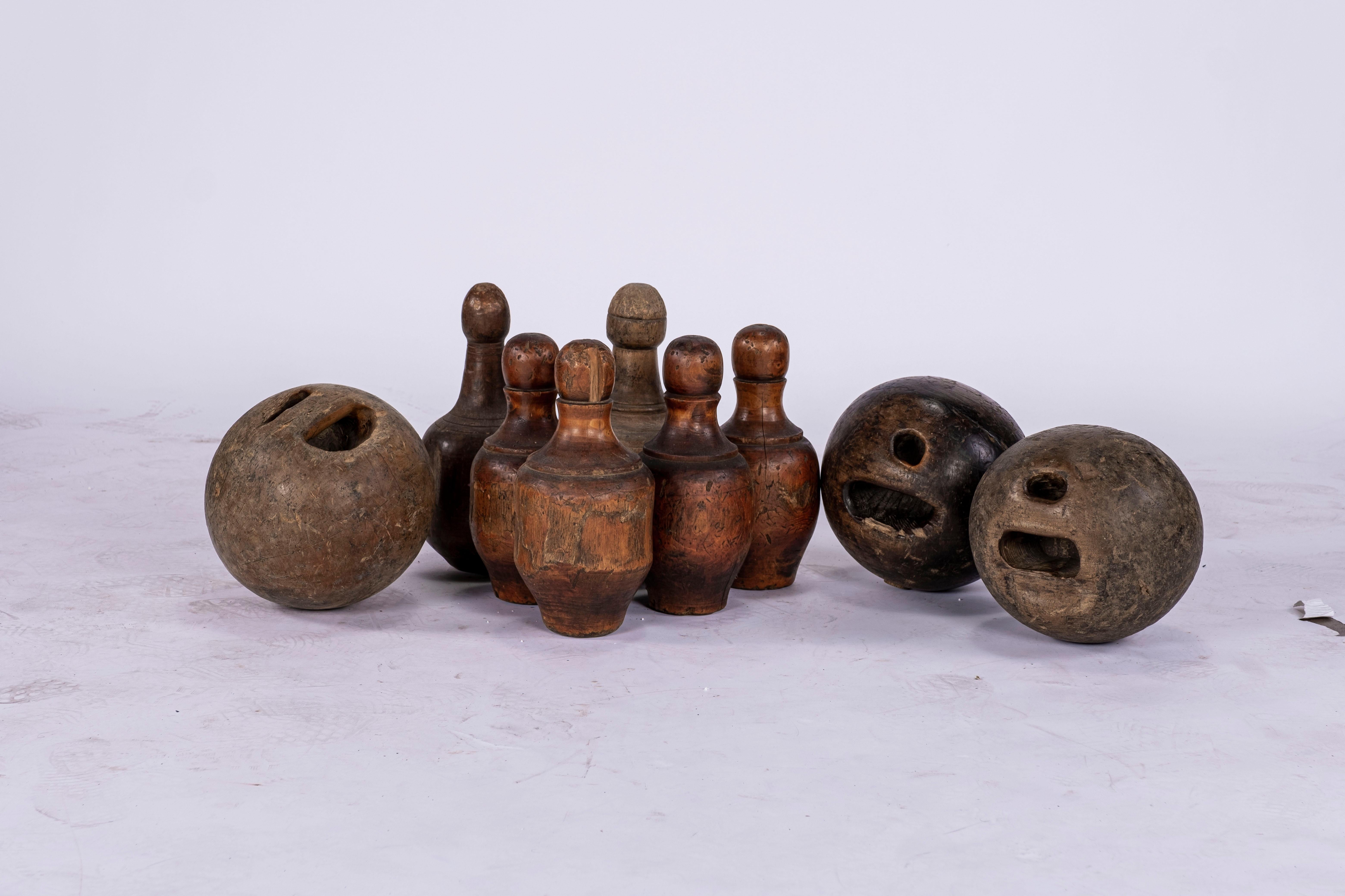 19th century French bistro lawn bowling set. 6 pins and 3 bowling balls. Bowling Balls are smooth where the fingers have been placed. Various sizes of pins and balls.