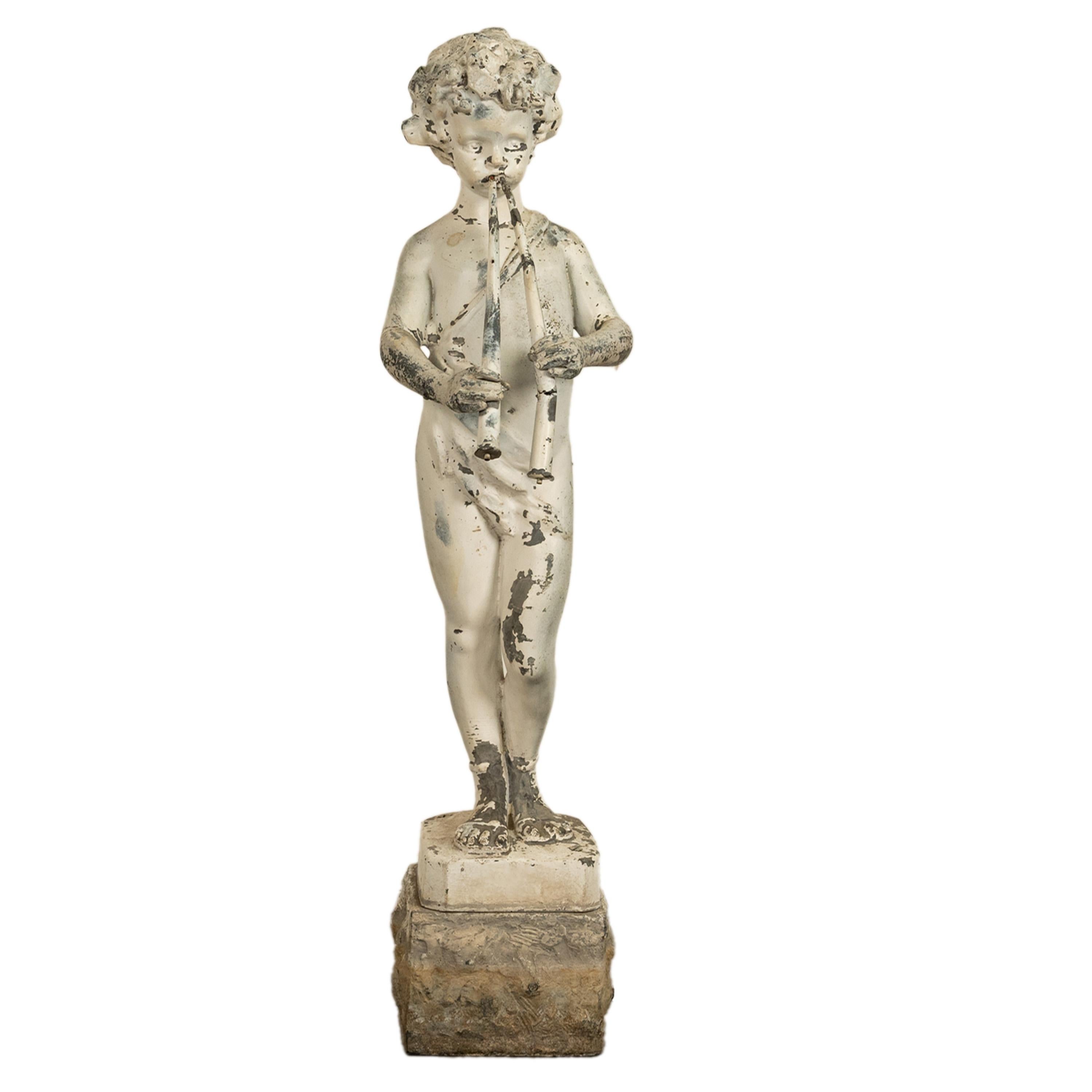 A good antique French lead figure of a delicately featured boy, or Pan playing pipes raised on a stone plinth, circa 1880.
Created as a fountain, and still can be used as a fountain head but equally wonderful as a stand alone garden sculpture. The