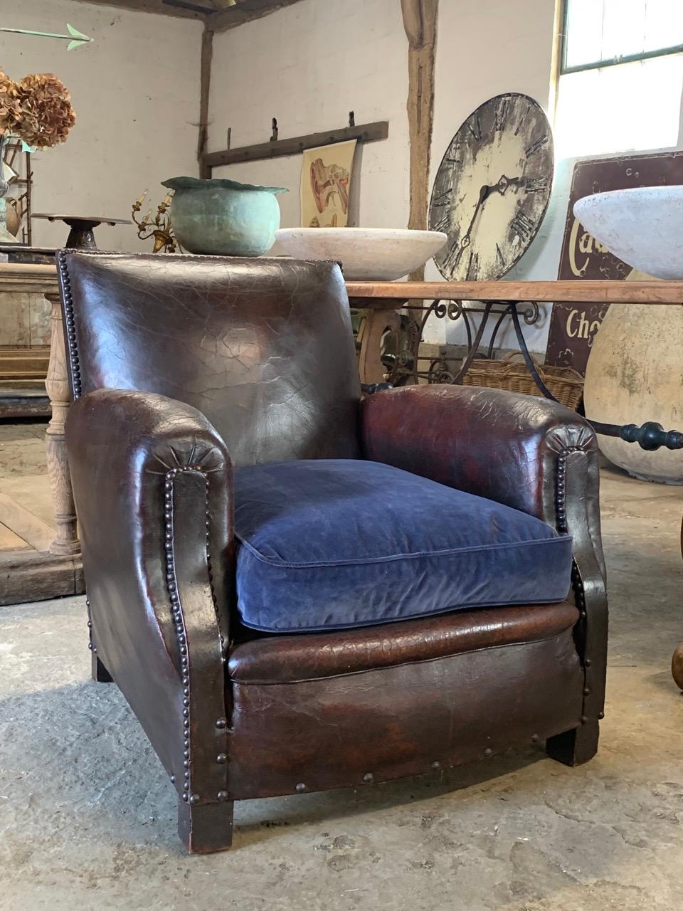 A great looking antique French leather armchair with brass studding. The springs and frame are solid and ready to use. Wear to the leather in places from age and use with a couple of old repairs which is part of the look.