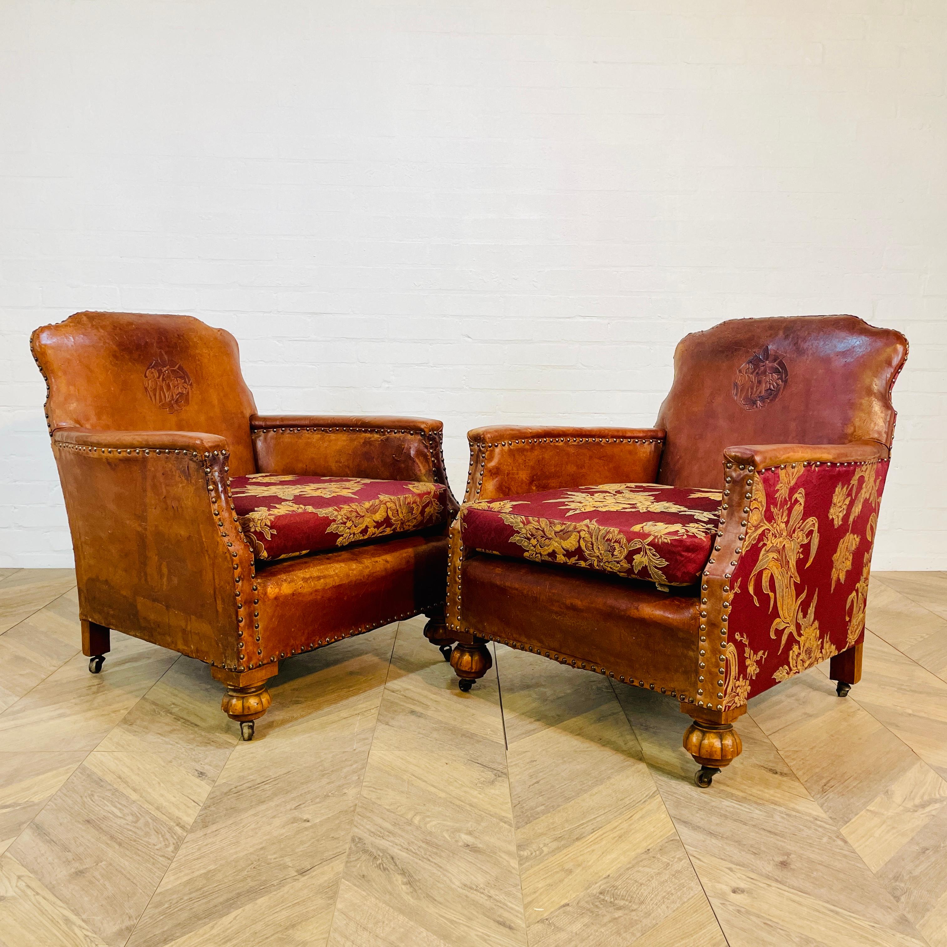 A Lovely Pair of Arts & Crafts, French Leather Club Chairs on Original Brass Castors - circa 1920s.

The chairs have wonderful proportions, shape and a lovely warm patina. 

The seat cushions and sides to one of the chairs has been professionally