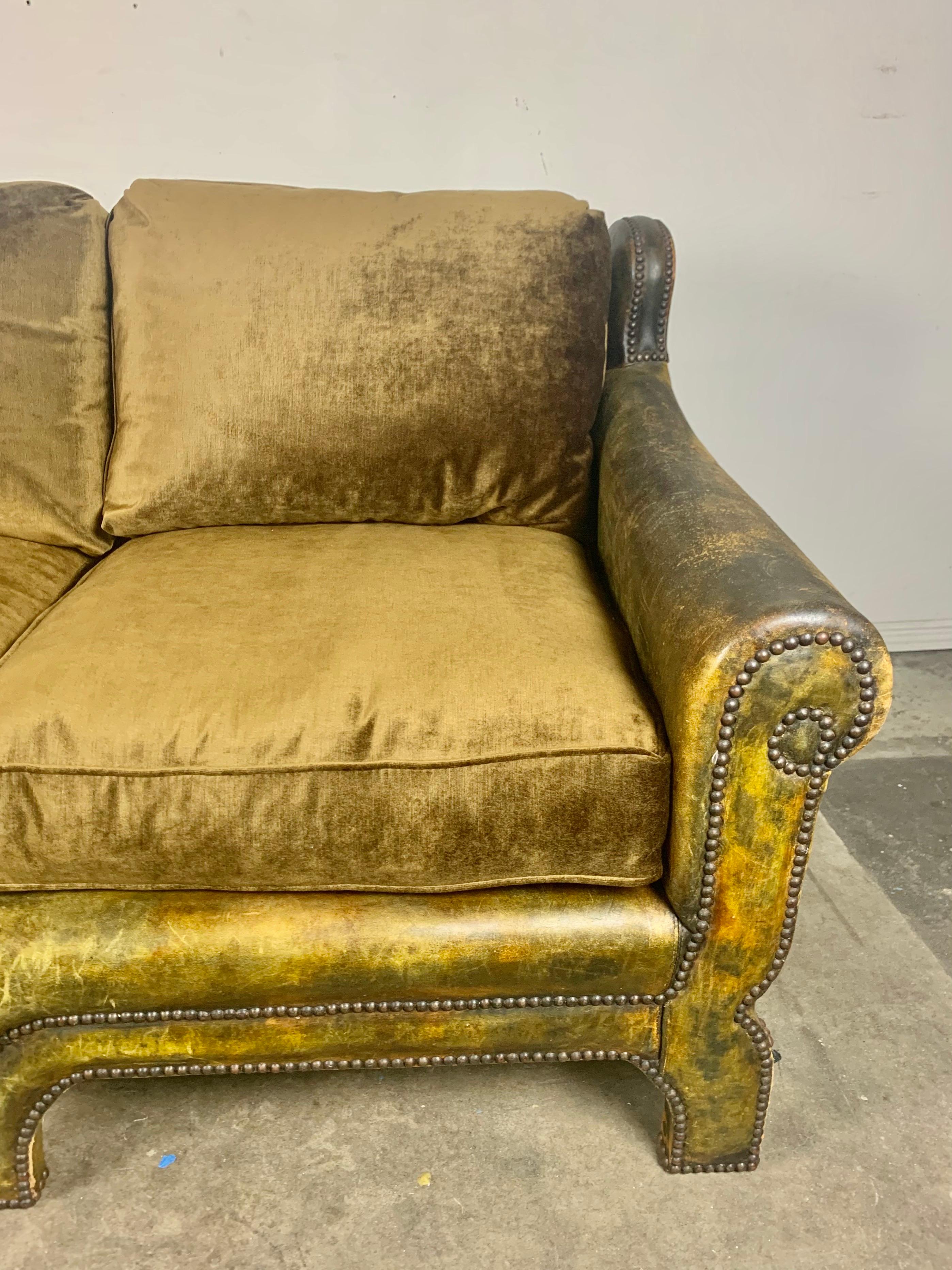 Antique French leather upholstered sofa with original nailhead trim detail. New loose velvet cushions were created to coordinate with the original leather. The back cushions are down filled while the seat cushions are down wrapped. The patina is