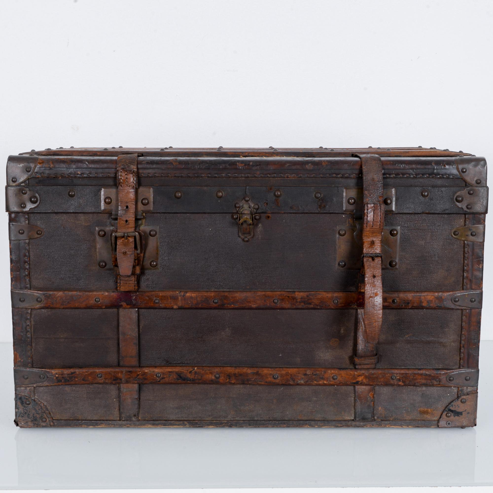 A beautifully aged French leather suitcase from the turn of the 20th century. Featuring a blue or white striped cloth interior, two leather straps, clasp, and interior red leather pocket this case works open or shut, standing alone or full of