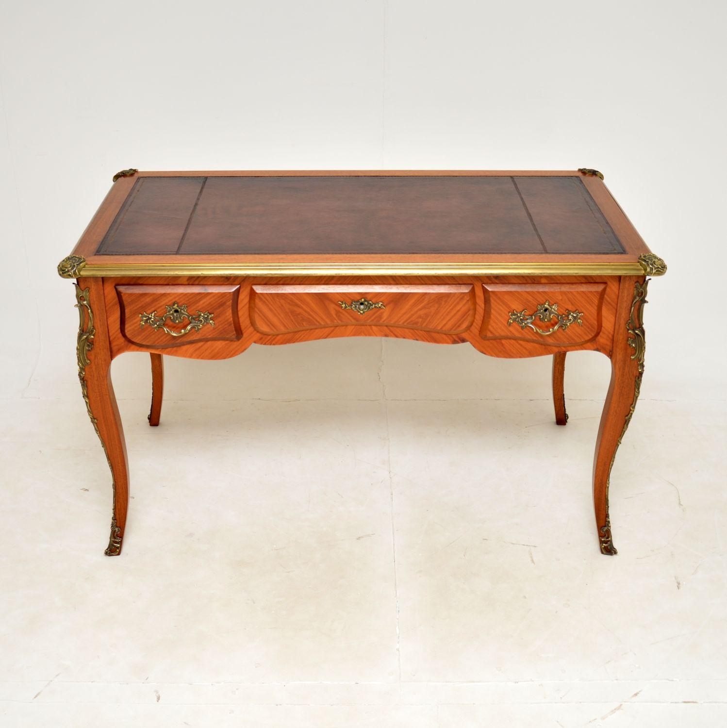 A stunning antique French leather top desk. This was made in France, it dates from around the 1950’s.

The quality is outstanding, this is a great size, with lots of nice features. The burgundy leather top is hand coloured and gold tooled, in