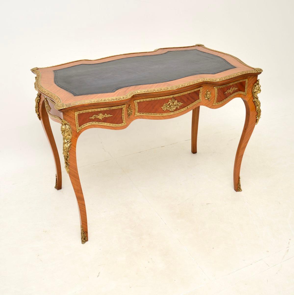 A stunning antique French leather top bureau plat desk, made in France and dating from around the 1930’s.

This is of outstanding quality, with beautifully cast ormolu mounts throughout. The wood is walnut, which has a gorgeous colour tone and grain