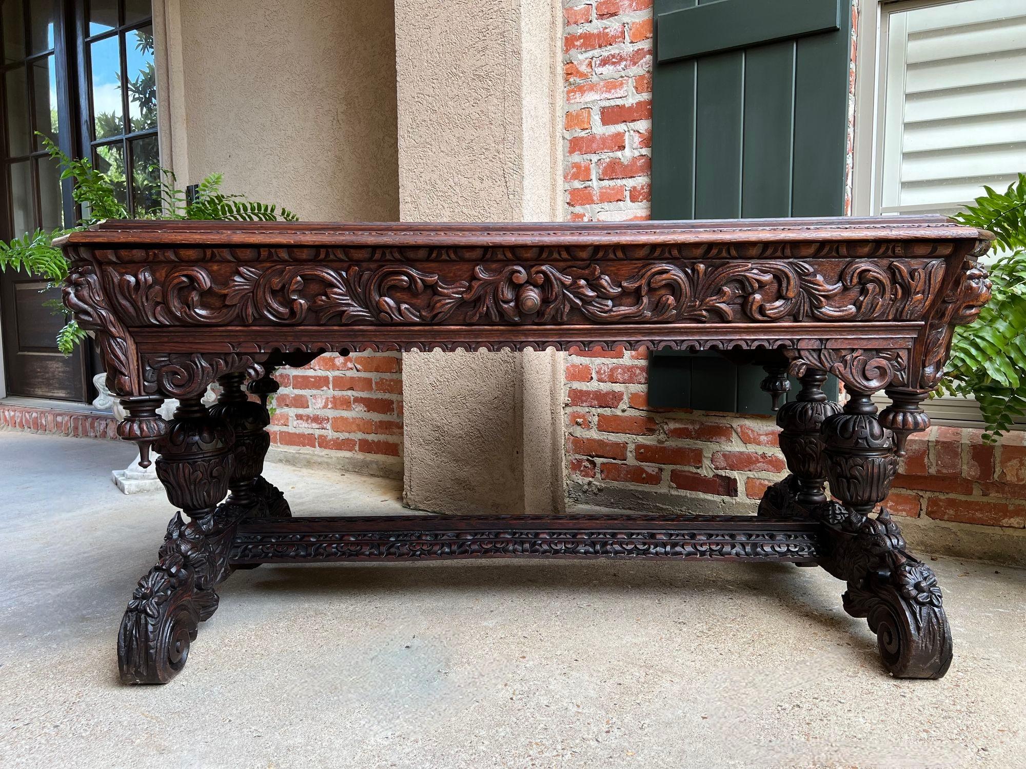 Antique French Library Table Desk Bureau Plat Renaissance Carved Oak Gothic.

Direct from France, an elegant antique French carved library table or “bureau plat” desk, also commonly referred to as a ‘dolphin table’, for the ornately carved