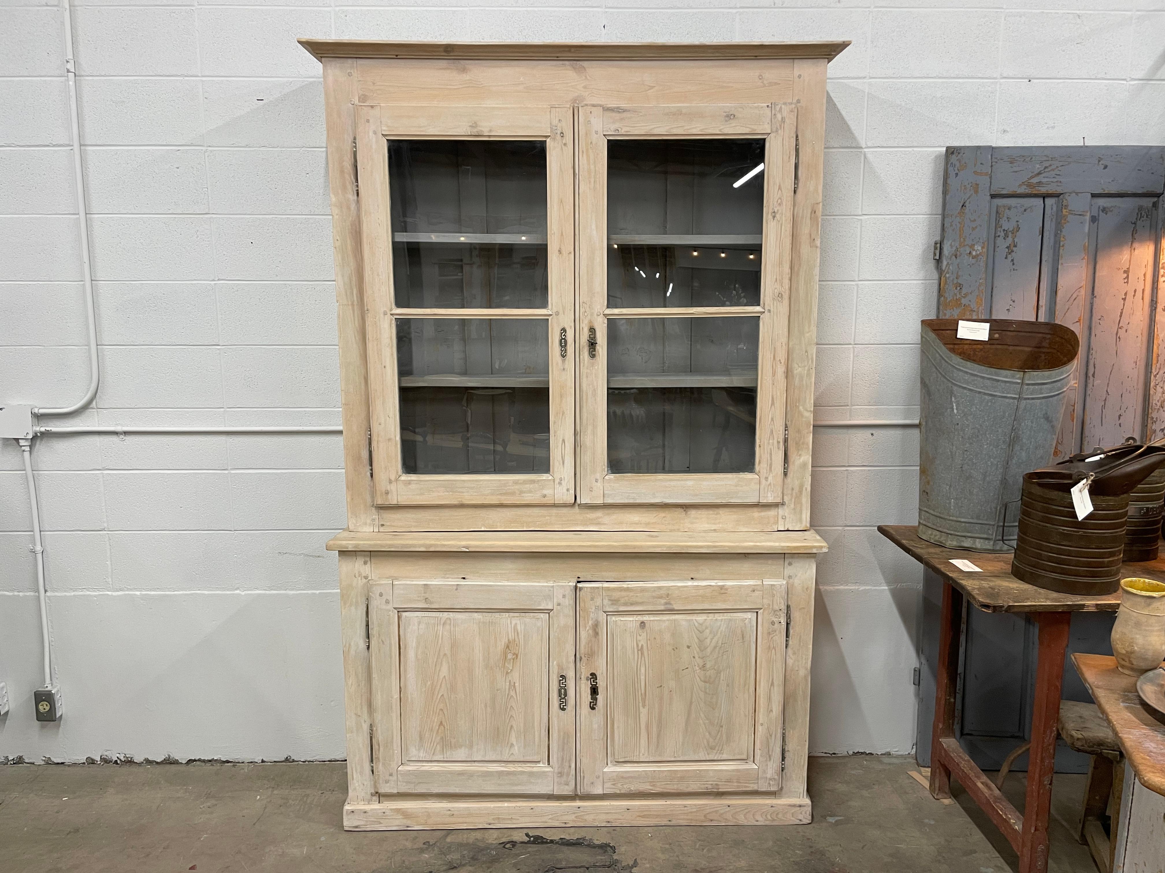 Antique French  limed pine buffet a de corps, with large glazed doors over 2 blind doors. It has 2 shelves above and one below. Original hinges and escutcheons sets off this understated piece with later French blue washed interior. Lovely peg