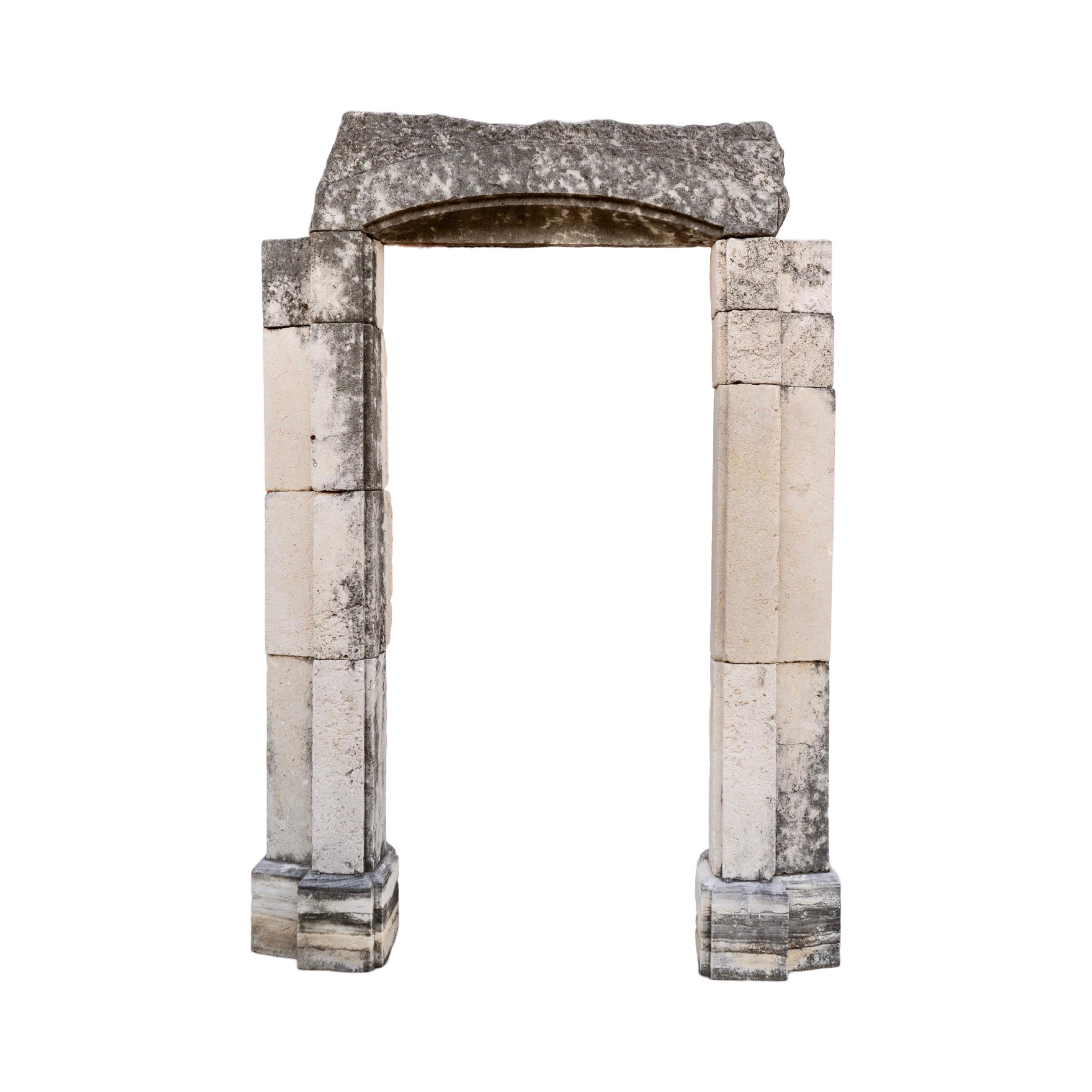 This reclaimed antique French limestone archway from the 18th century adds character and personality to any garden space. Made out of limestone, it boasts a unique and weathered appearance, perfect for those seeking a one-of-a-kind addition to their