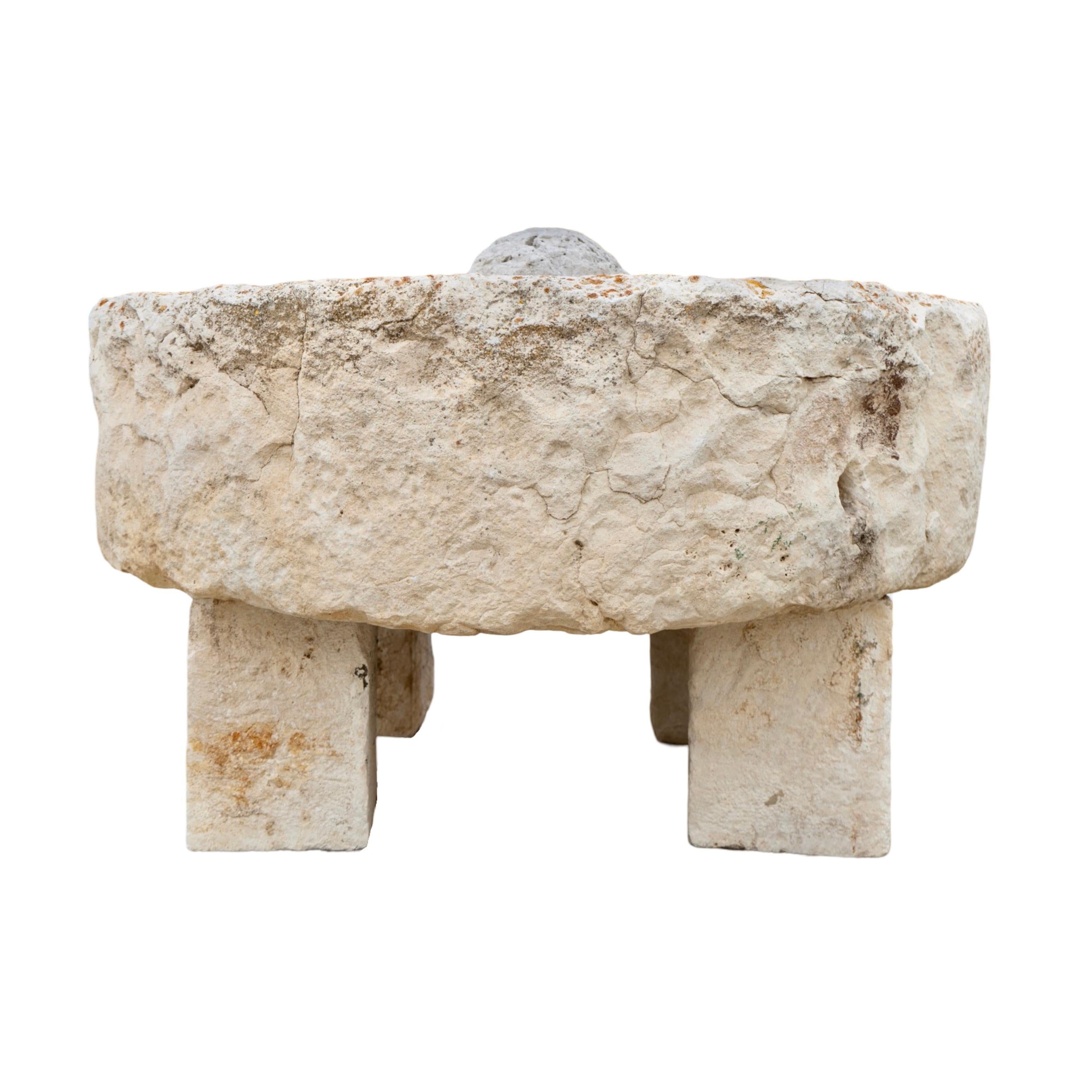 This 1750s reclaimed Antique French Circular Trough boasts a unique circular style and is made out of limestone, giving it character and charm. The limestone ball slab in the center can be removed or moved around, and there is a pre-drilled hole