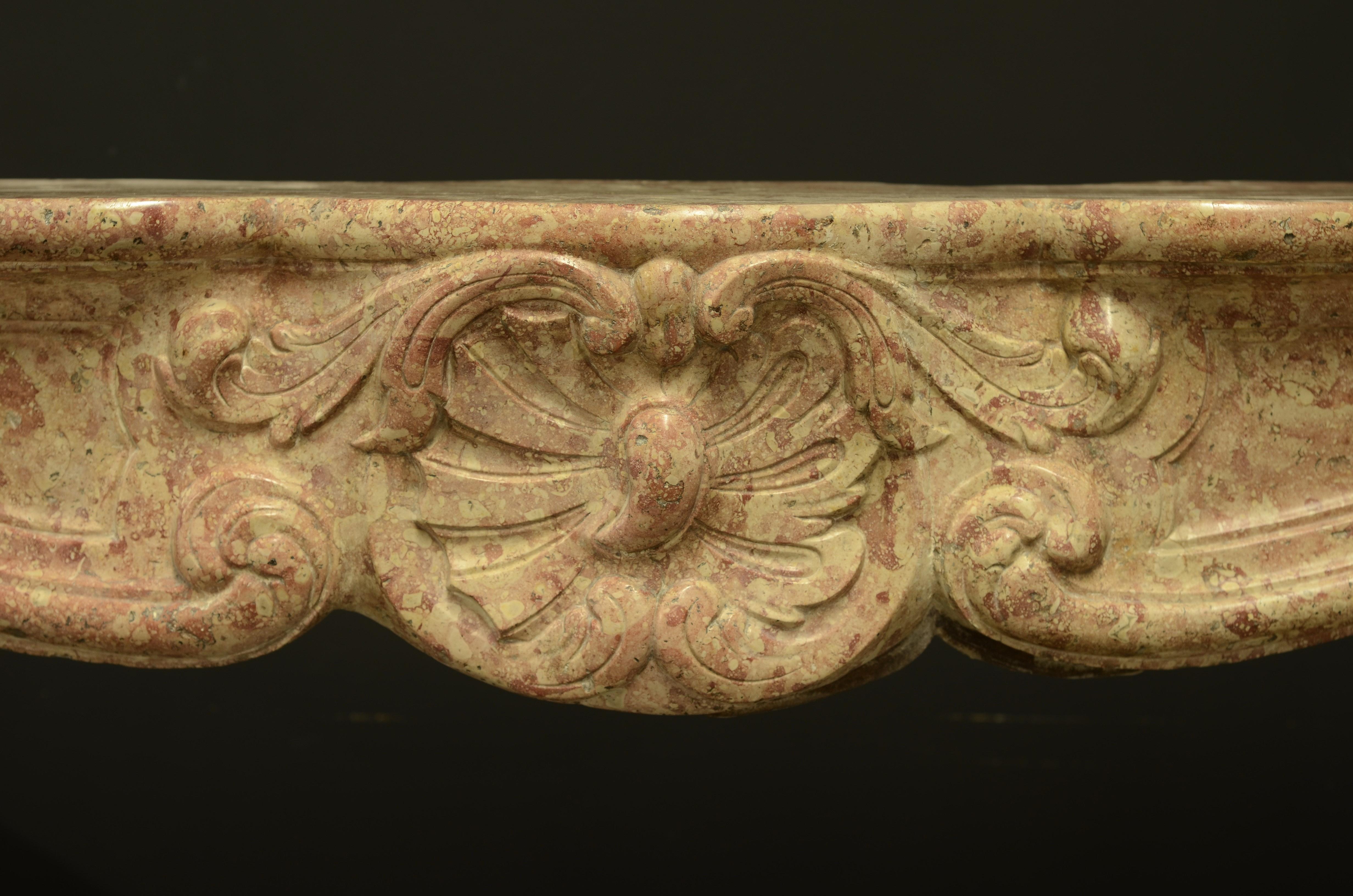 A nice warm colored and decorative early 19th century French Louis XV fireplace mantel.
Opening dimensions: 
Highest height: 38.58 inch or 98 cm 
Lowest height: 35.82 inch or 91 cm
Width: 51.18 inch or 130 cm

Has been restored.

Ready to be shipped