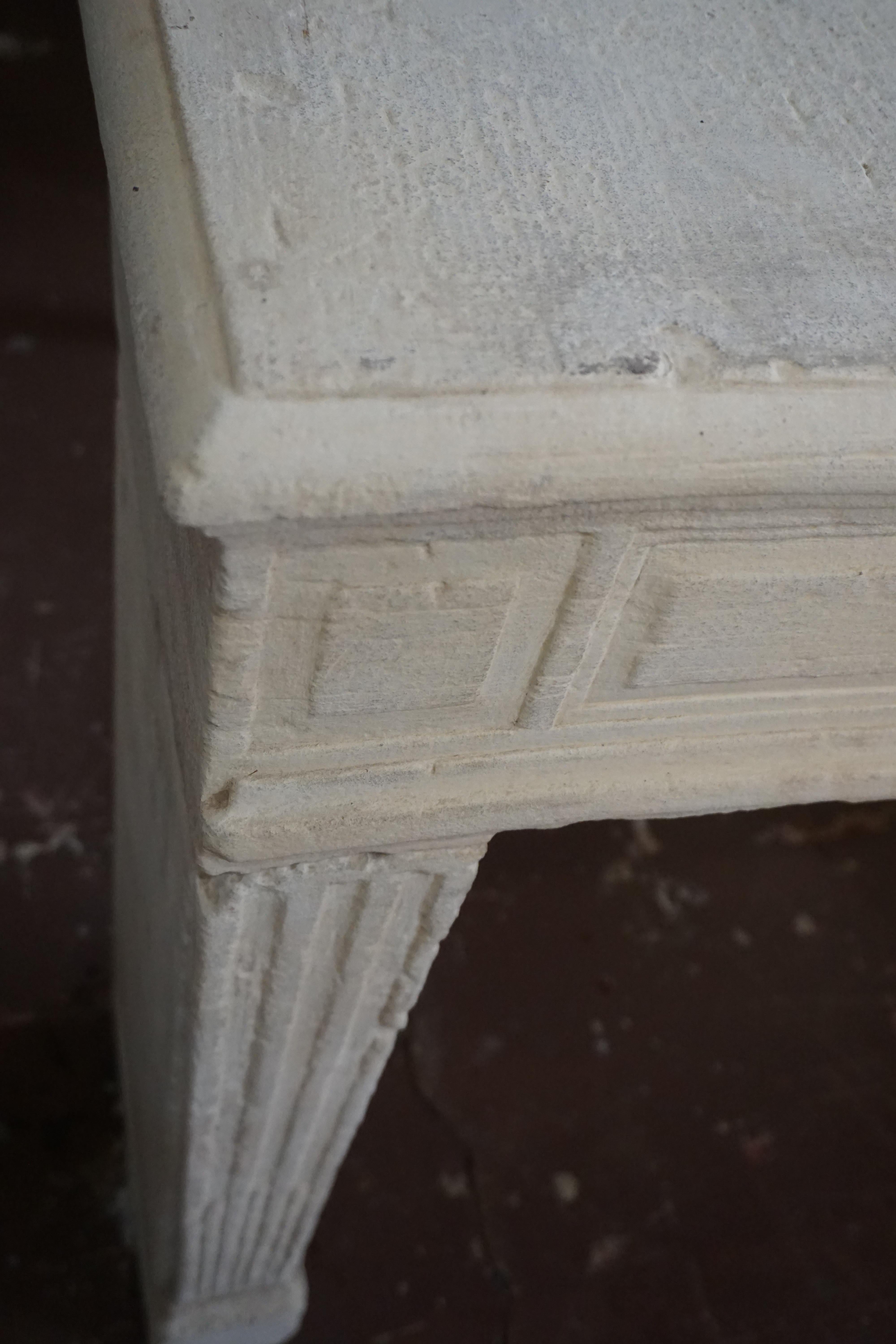 This antique limestone mantel comes from France, circa 1820. 

Measurements: 48'' W x 38'' H x 12'' D.