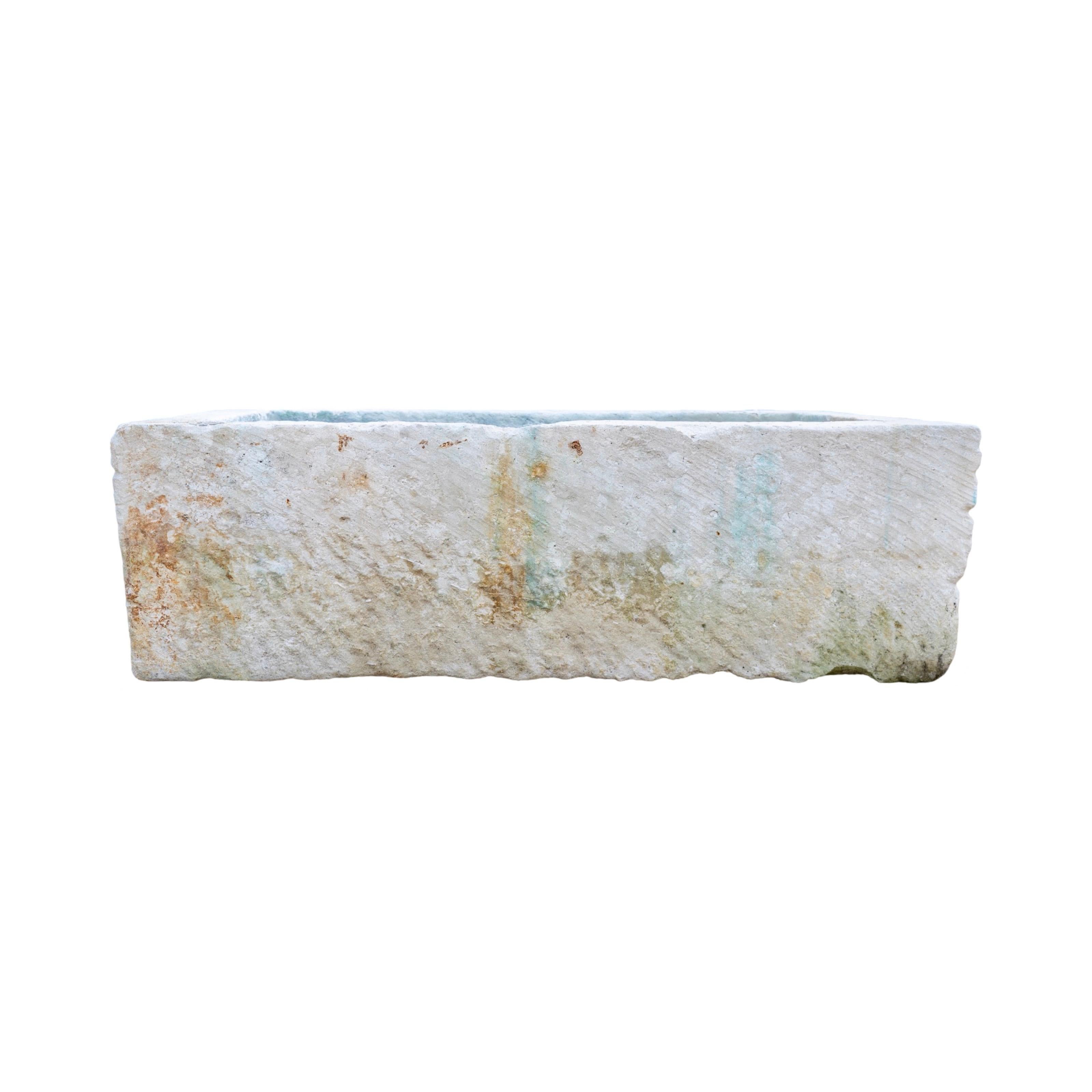 This exceptional 18th-century French limestone trough, reclaimed from a historic home, boasts a rich, antique character. With its authentic age and natural wear, it exudes timeless charm. The large size adds a commanding presence, making it a