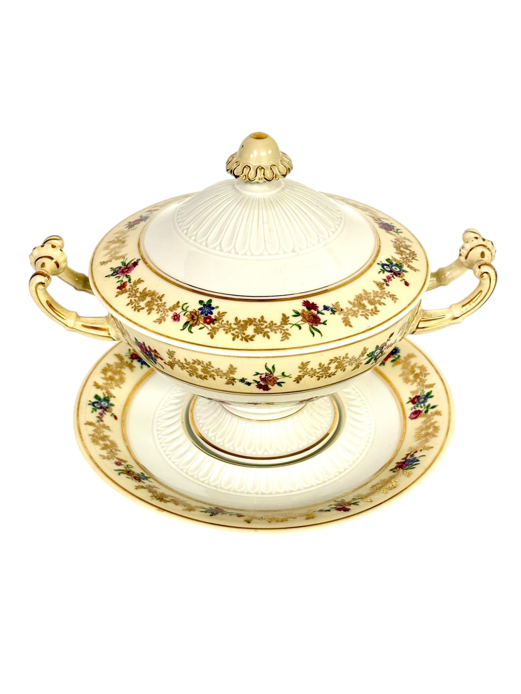 This rare and elegant French covered bouillon bowl was crafted by Raynaud & Cie, one of the most esteemed porcelain manufacturers in Limoges. Marked with both the “R & Cᵒ Limoges France” stamp and the distinctive swan hallmark, this refined piece