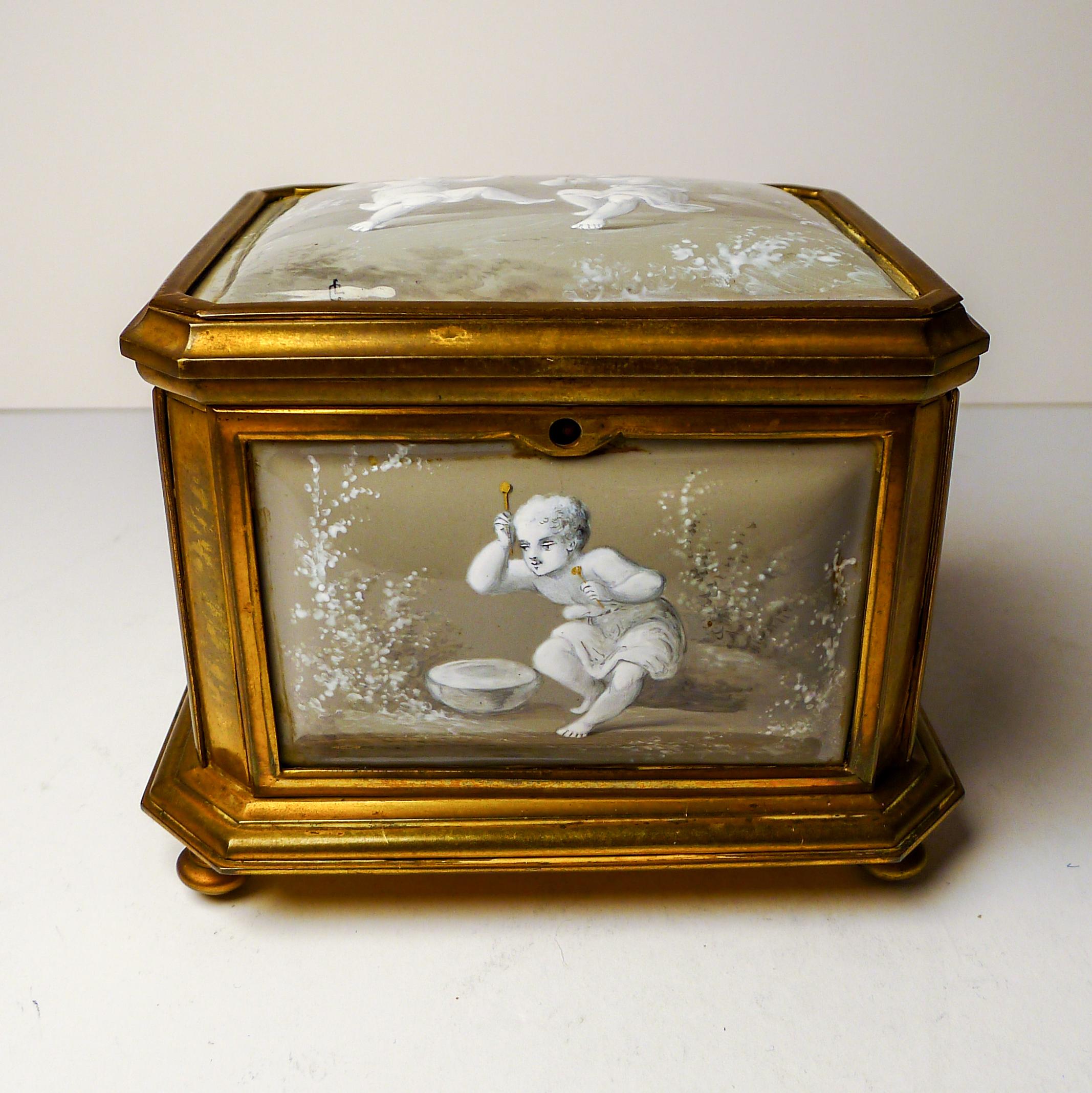 An absolute gem, made in France in around 1860, this charming box or casket is made from a heavy Ormolu and standing on four original feet.
The undamaged five Limoges enamel panels are what this such a special piece, in a fashionable soft French