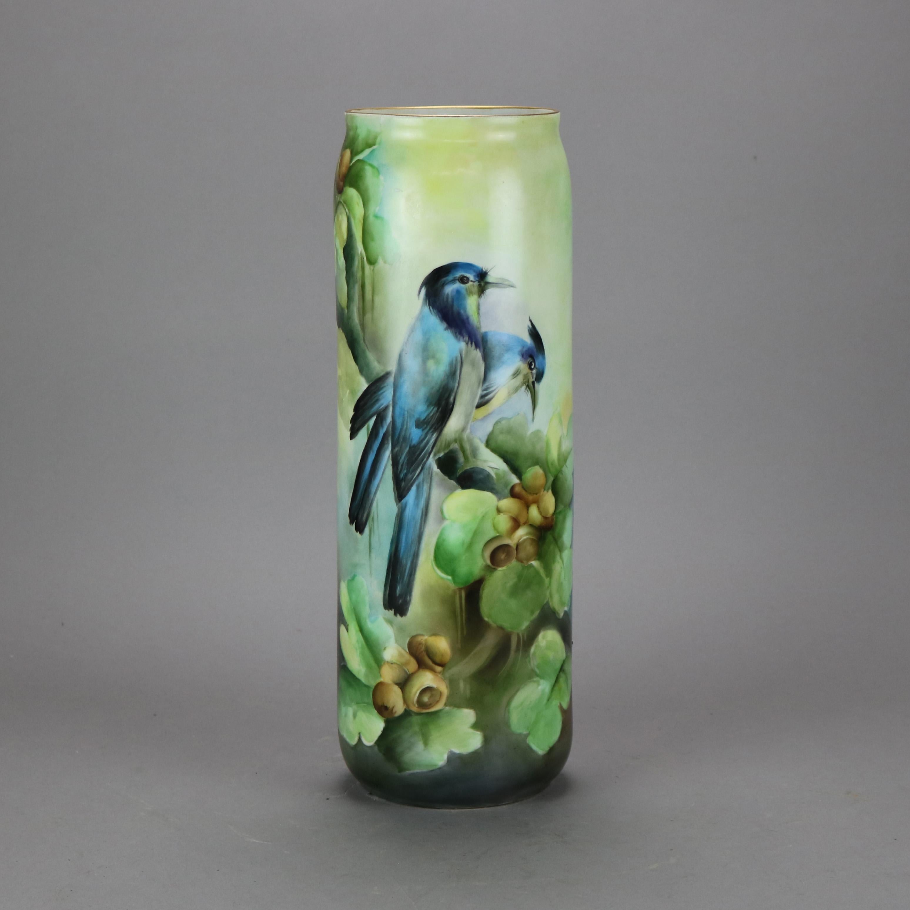 An antique French Limoges vase offers porcelain construction in cylinder form with hand painted garden scene with birds (blue jays) and flowers, marked on base as photographed, c1900

Measures - 15.25''H x 5''W x 5''D.
